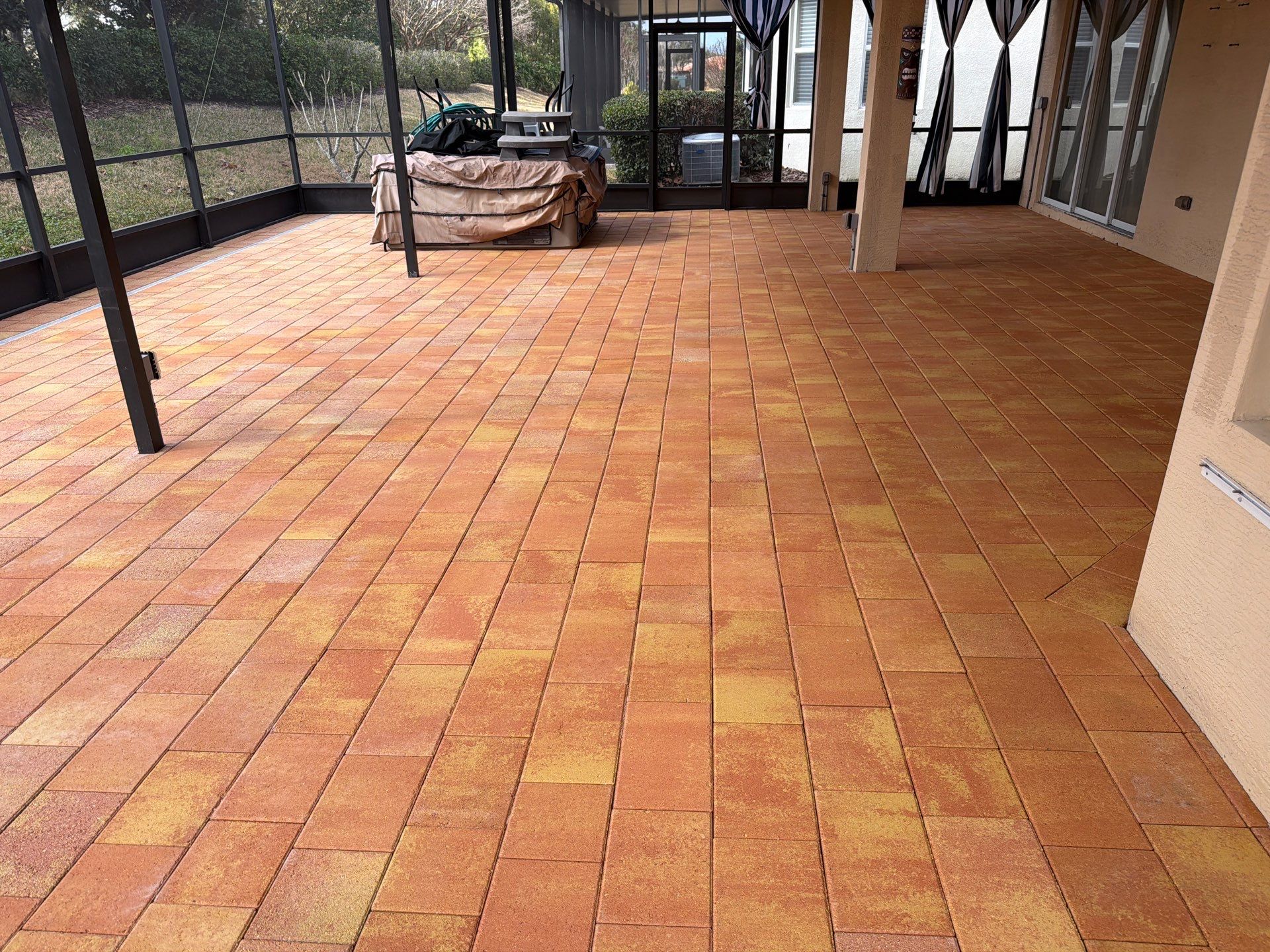 Paver Sealing for Herringbone Driveway and Screened Lanai in Valencia Lakes by Supreme Paver Experts