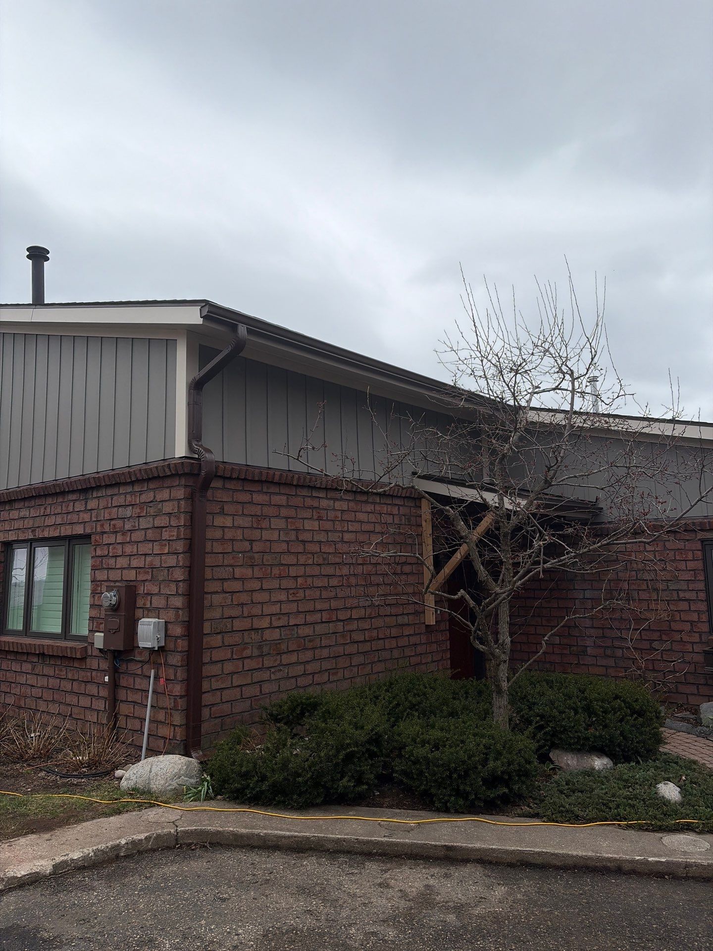 Gutter and Downspout Installation for Petoskey Residential Brick Exterior by Rainbow Seamless Systems