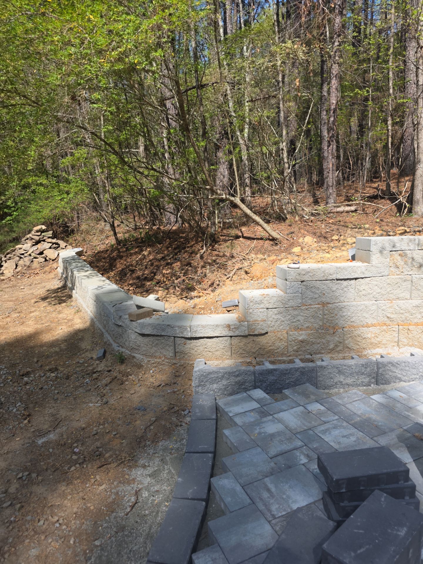 Pittsboro Outdoor Living Transformation – Retaining Wall, Paver Patio & Elevated Deck by Elite Remodeling and Design LLC