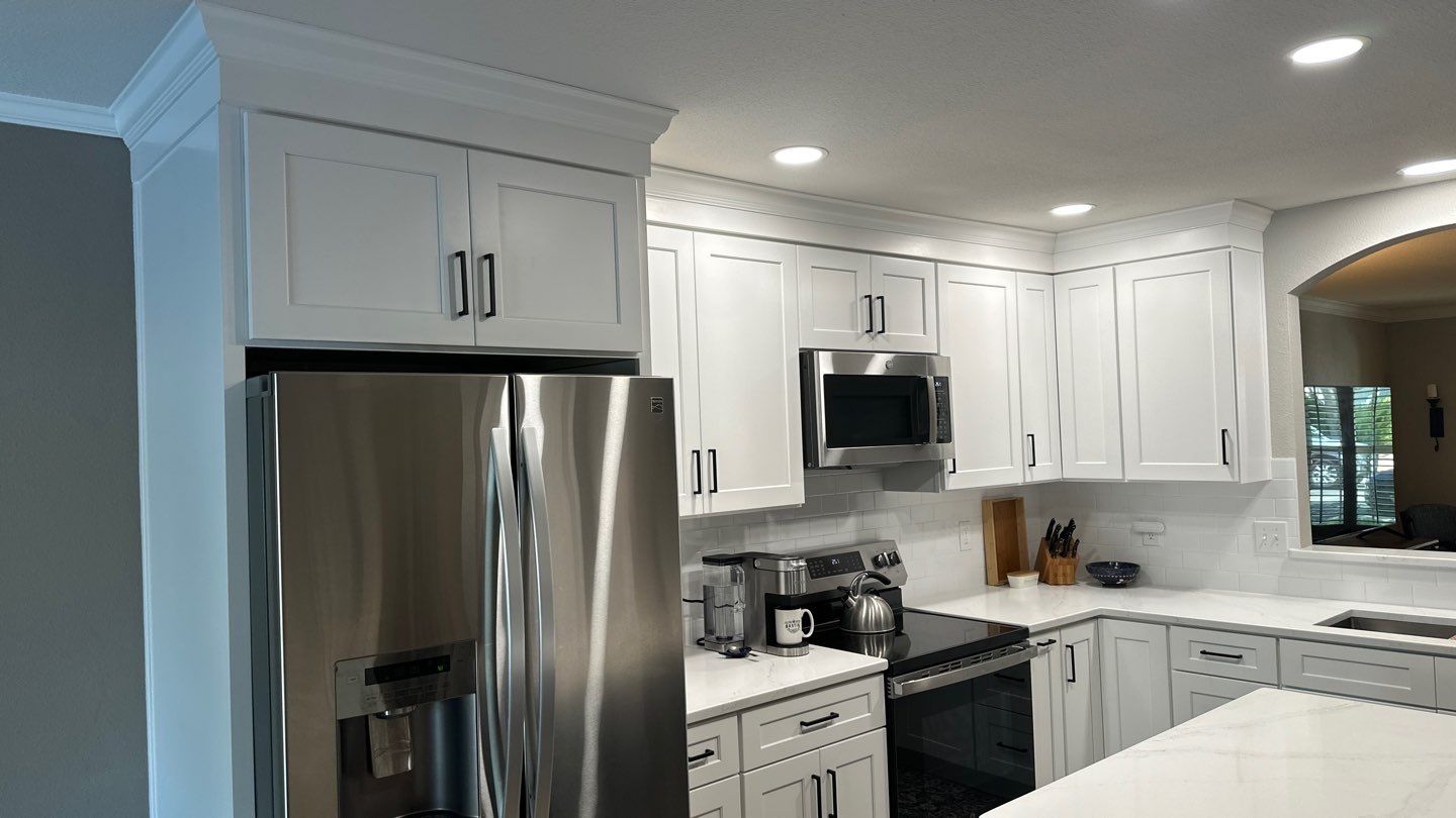 Live Oak Kitchen Refresh Featuring White Shaker Cabinets and Navy Island by Legacy Bath and Kitchen 
