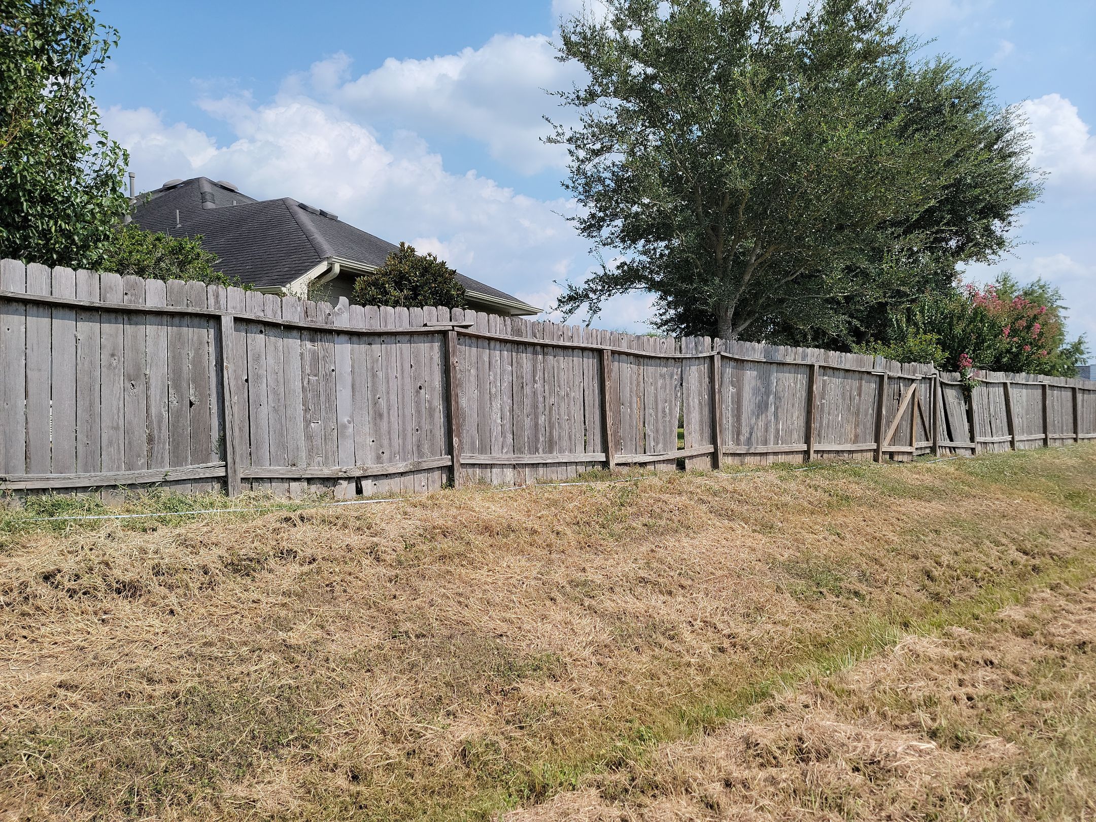 Beautiful Wood fence with metal posts by Tim's Fences