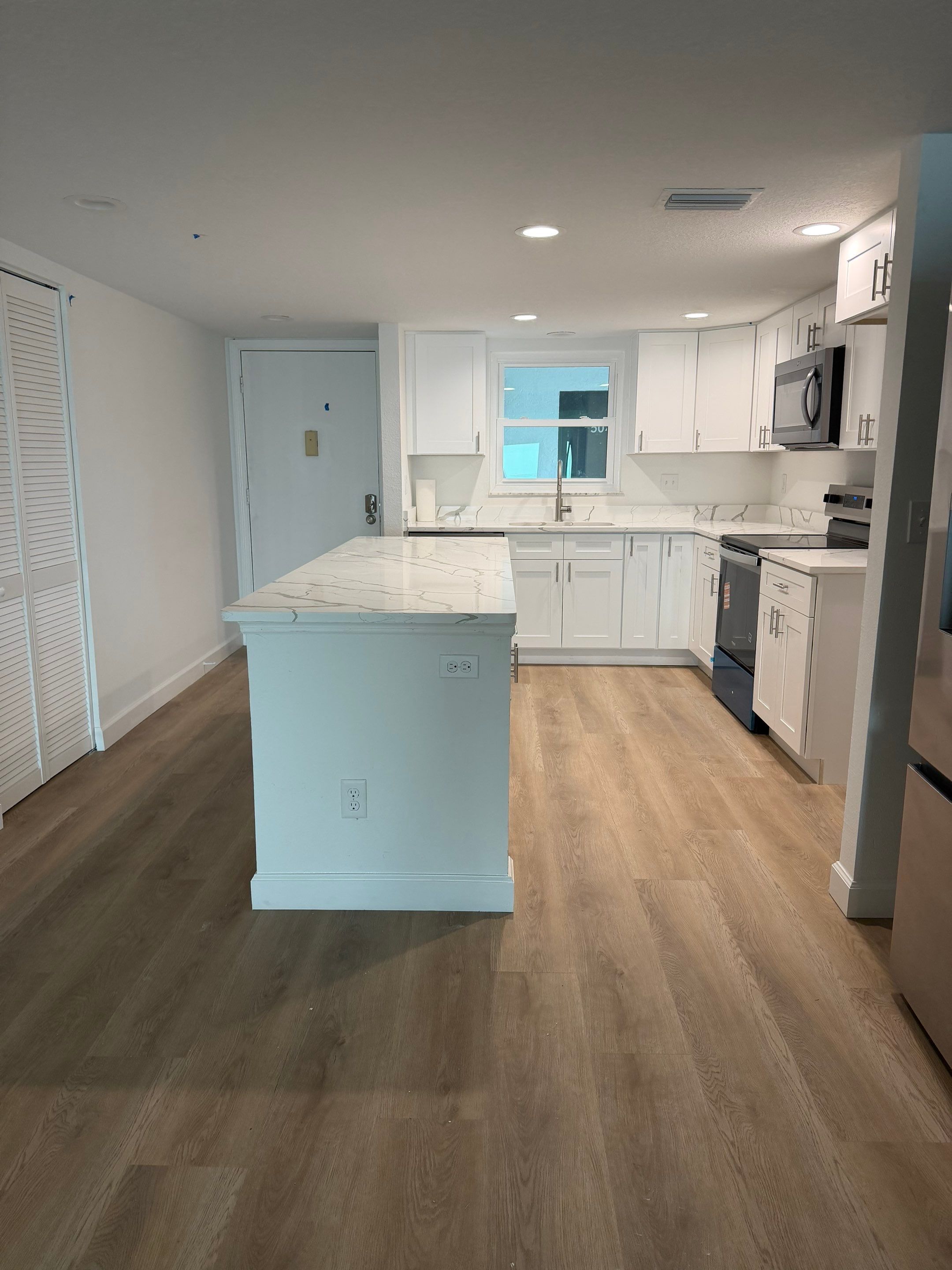 Full Condominium Remodel Featuring Aubrey Oak Flooring In Daytona Beach by Acies Renovations