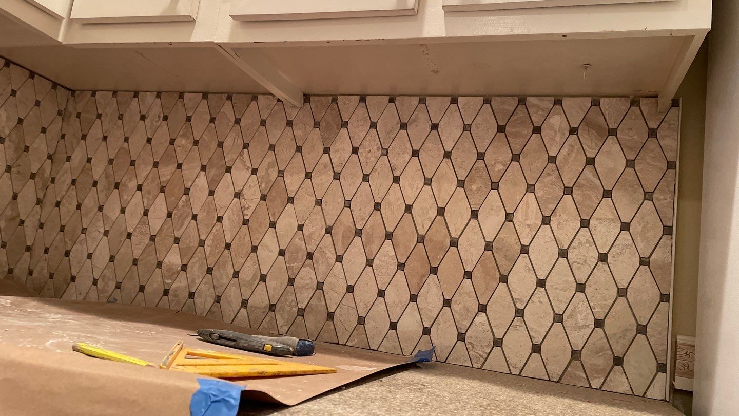 New Backsplash to Compliment the Countertops by Footprints Floors of Coastal Carolina