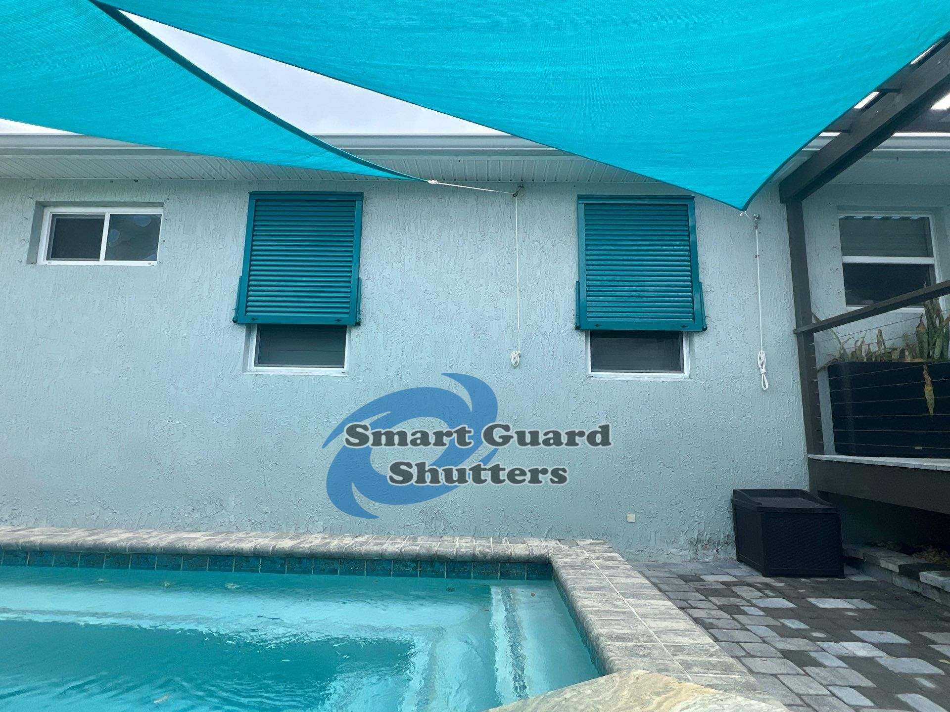 Impact Bahama Shutters in Water Blue by Smart Guard Shutters