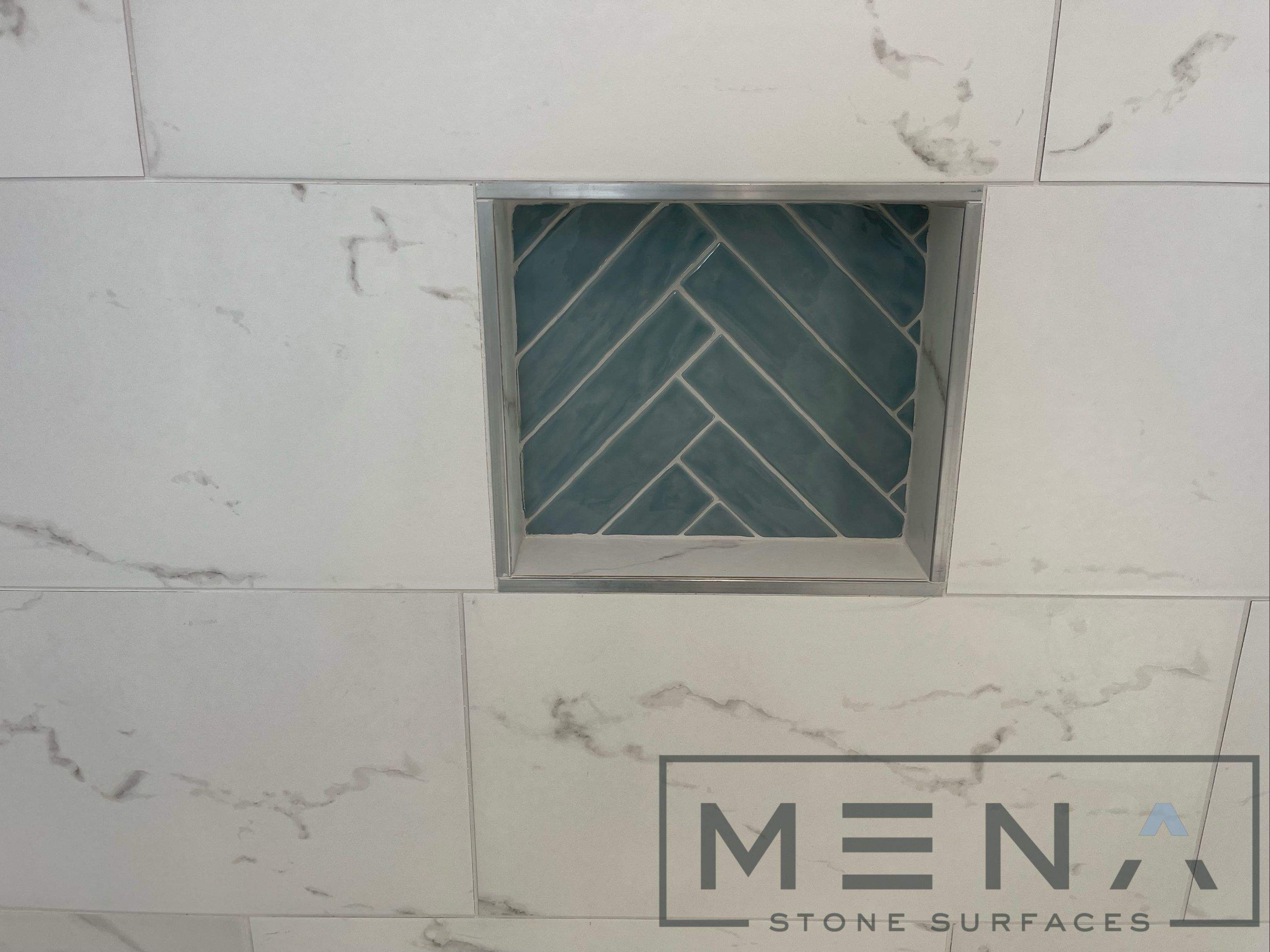 Complete Bathroom Remodel Featuring Marble Tile and Teal Herringbone Niche by Mena stone surfaces