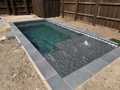 Modern Plunge Pool with Dark Interior and Paver Patio