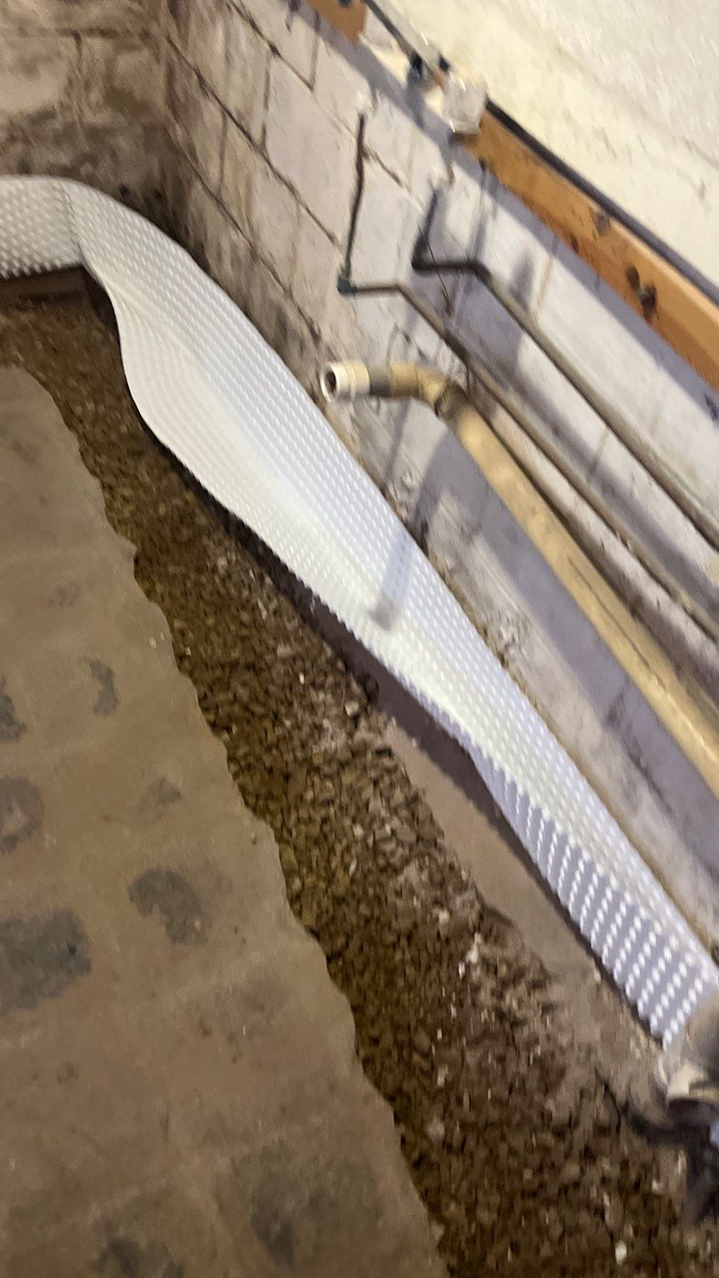 Interior drain tile system installation by ACE Waterproofing & Basement Solutions