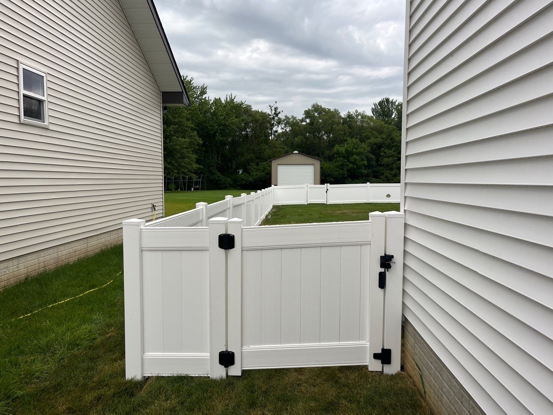 White Vinyl Privacy Fence With Pet Window in Cedar Falls by Perfect Picket Fence and Stain
