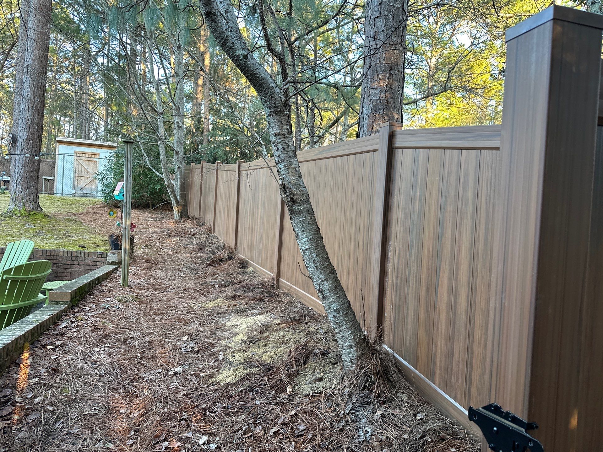 Mocha Walnut Wood-Grain Vinyl Privacy Fence Installation in Southern Pines by Superior Fence and Rail