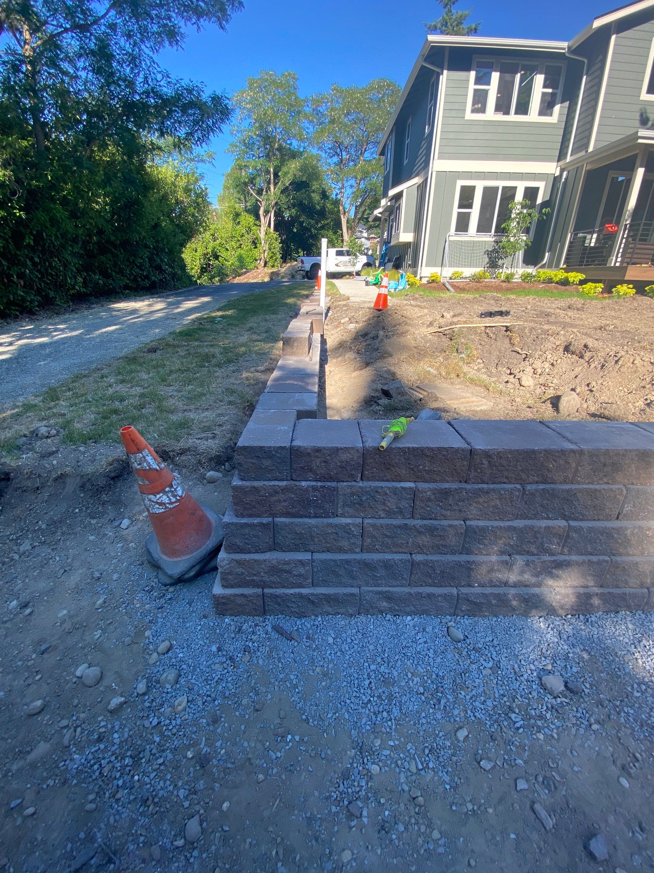 Patio Installation using Concrete, Retaining walls, and Turf install by Jireh Asphalt & Concrete Inc 
