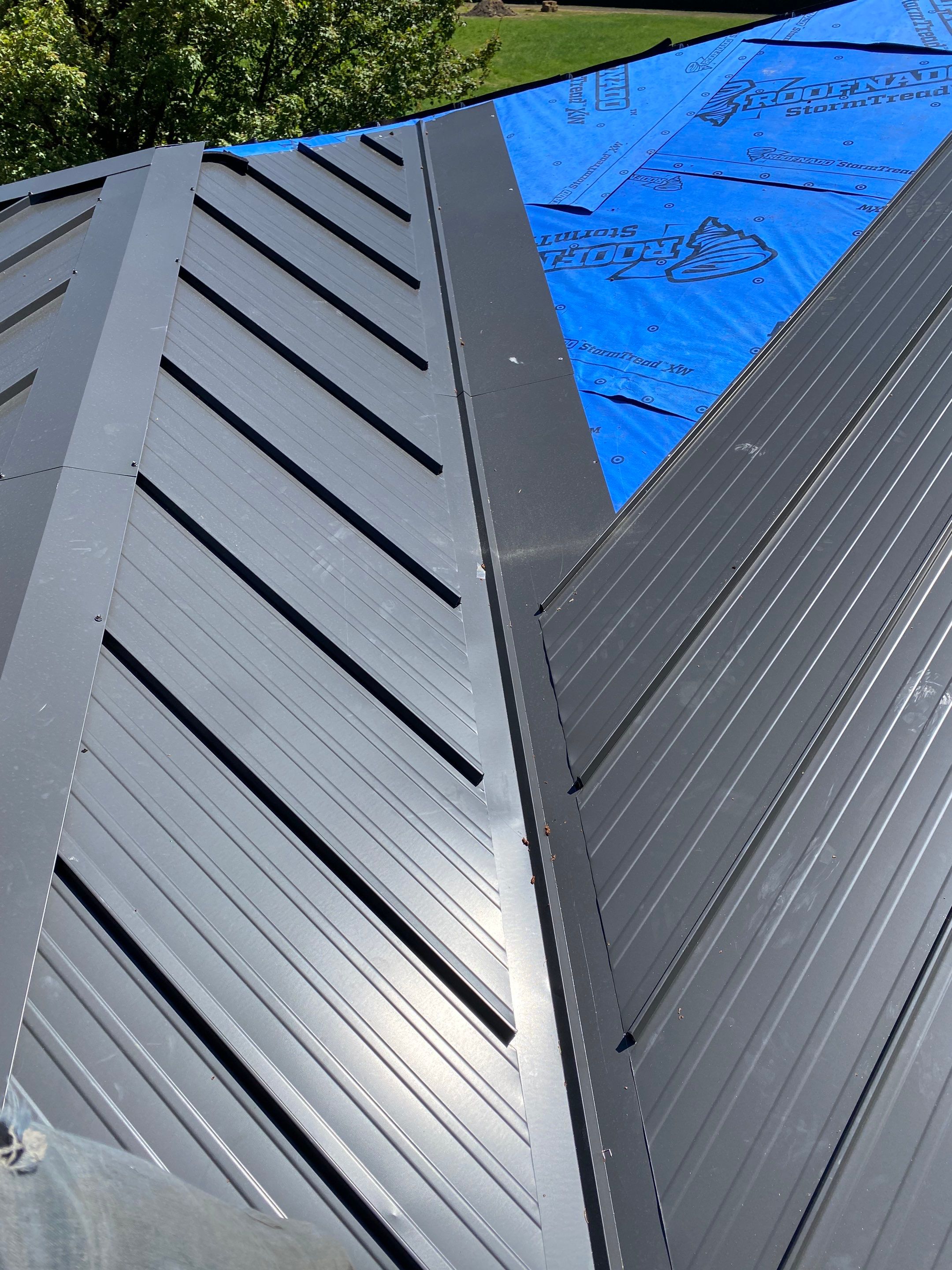 Residential Roofing Installation using 12" Prolok metal  by Top Notch Roofing Inc