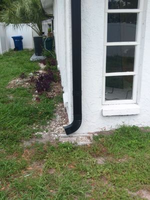 Black seamless gutters and downspouts installation in Sarasota, FL