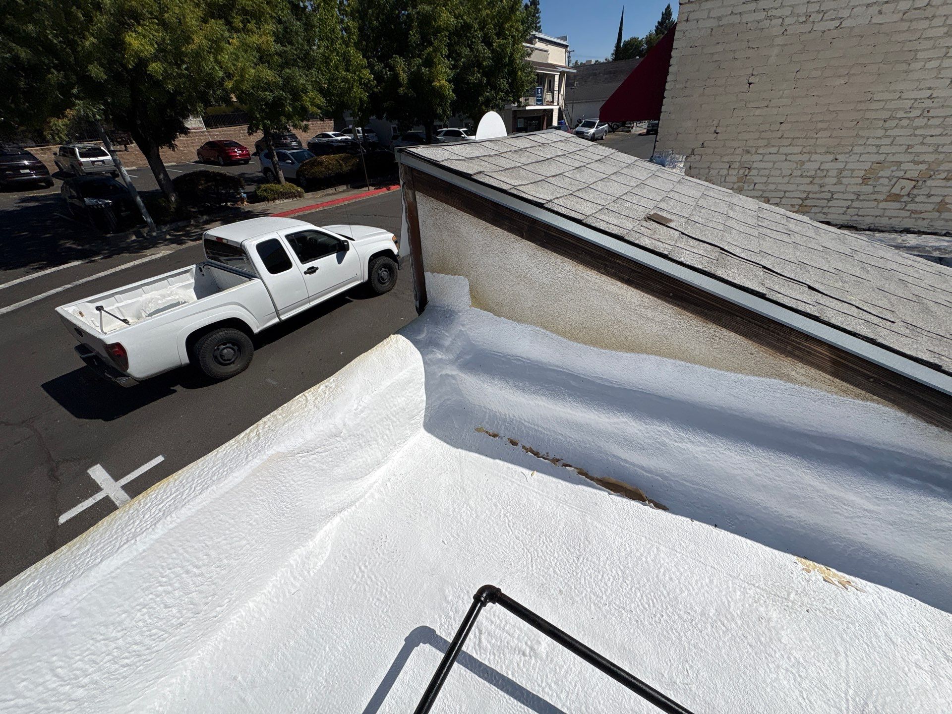 Foam and coatings on commercial roof by Straight Edge Roofing Inc