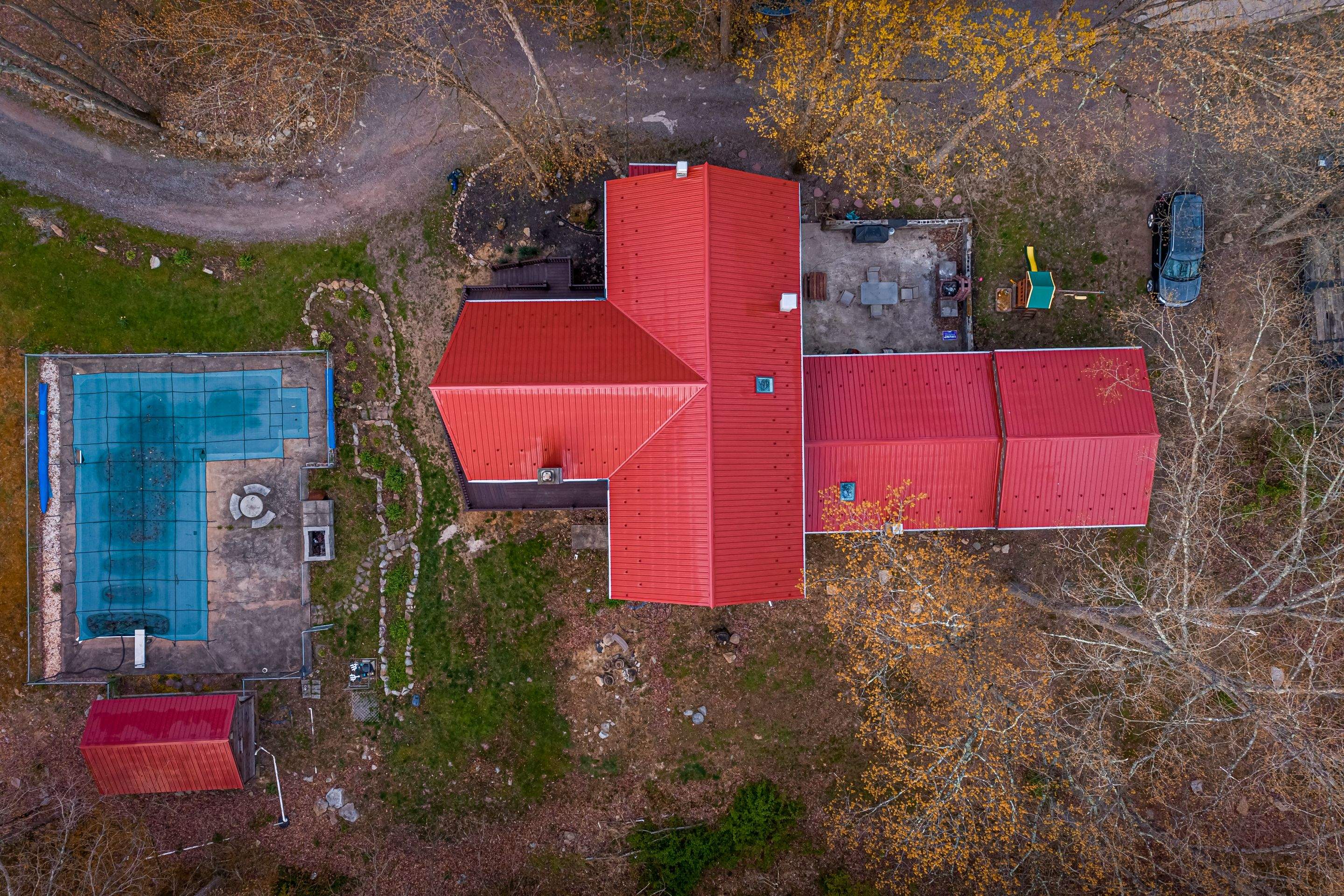 Metal Roof-barn red and new deck by Esh Builders