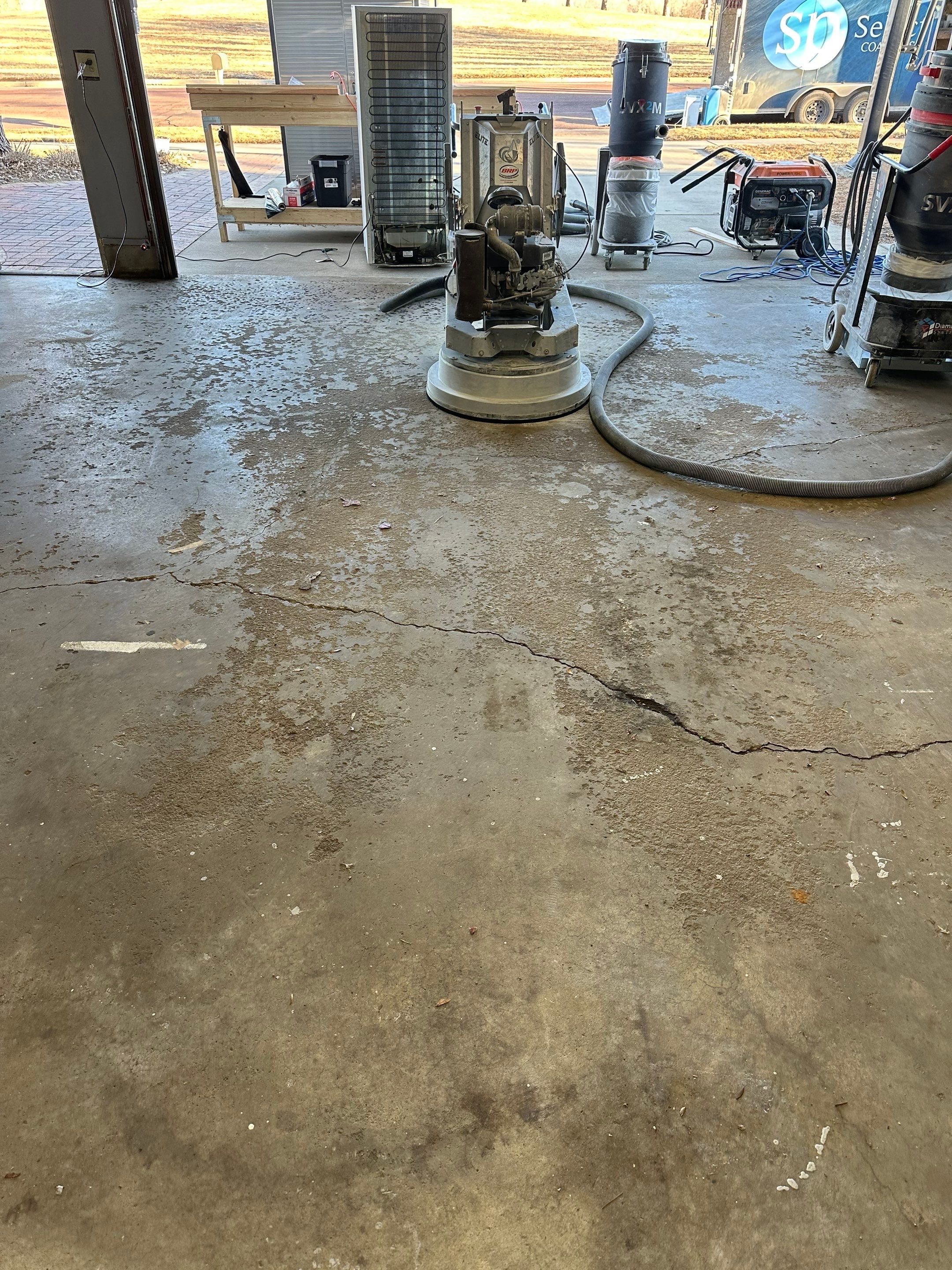 Multi-Colored Speckled Concrete Floor Coating Installation in Sioux Falls by Select Painting, Coatings & Garage Cabinets