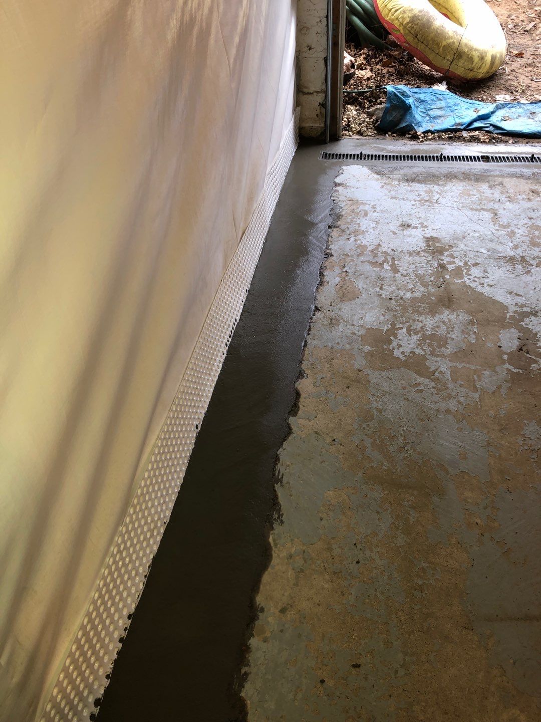 Basement Waterproofing using Drain tile system and a foundation wrap by ACE Waterproofing & Basement Solutions