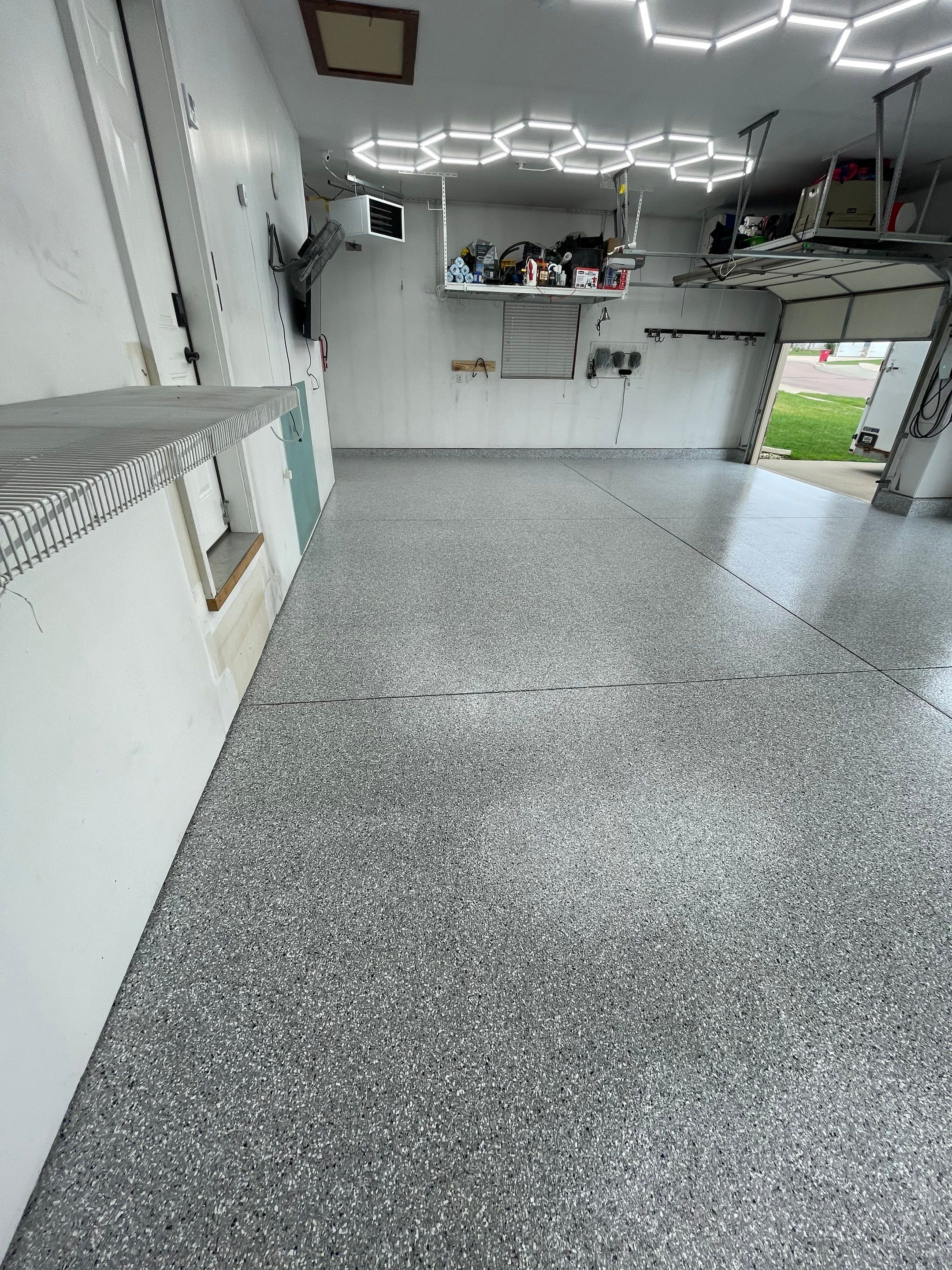 Feather Gray Epoxy Floor Coating Installation in Sioux Falls by Select Painting, Coatings & Garage Cabinets