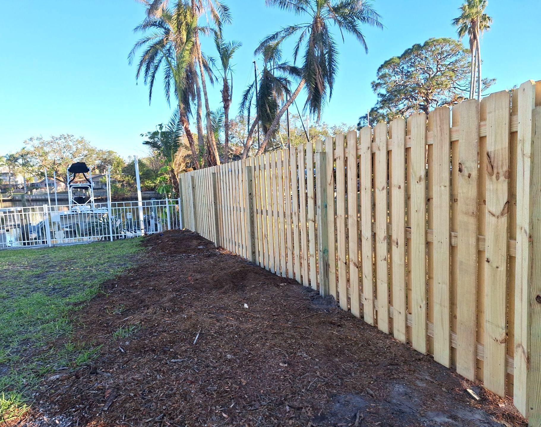 Wood Fence Installation using 6ft Pressure-Treated Wood Board-On-Board Privacy Fence with a 4Ft 3 Rail White Aluminum Fence by Asap fence and gates, LLC
