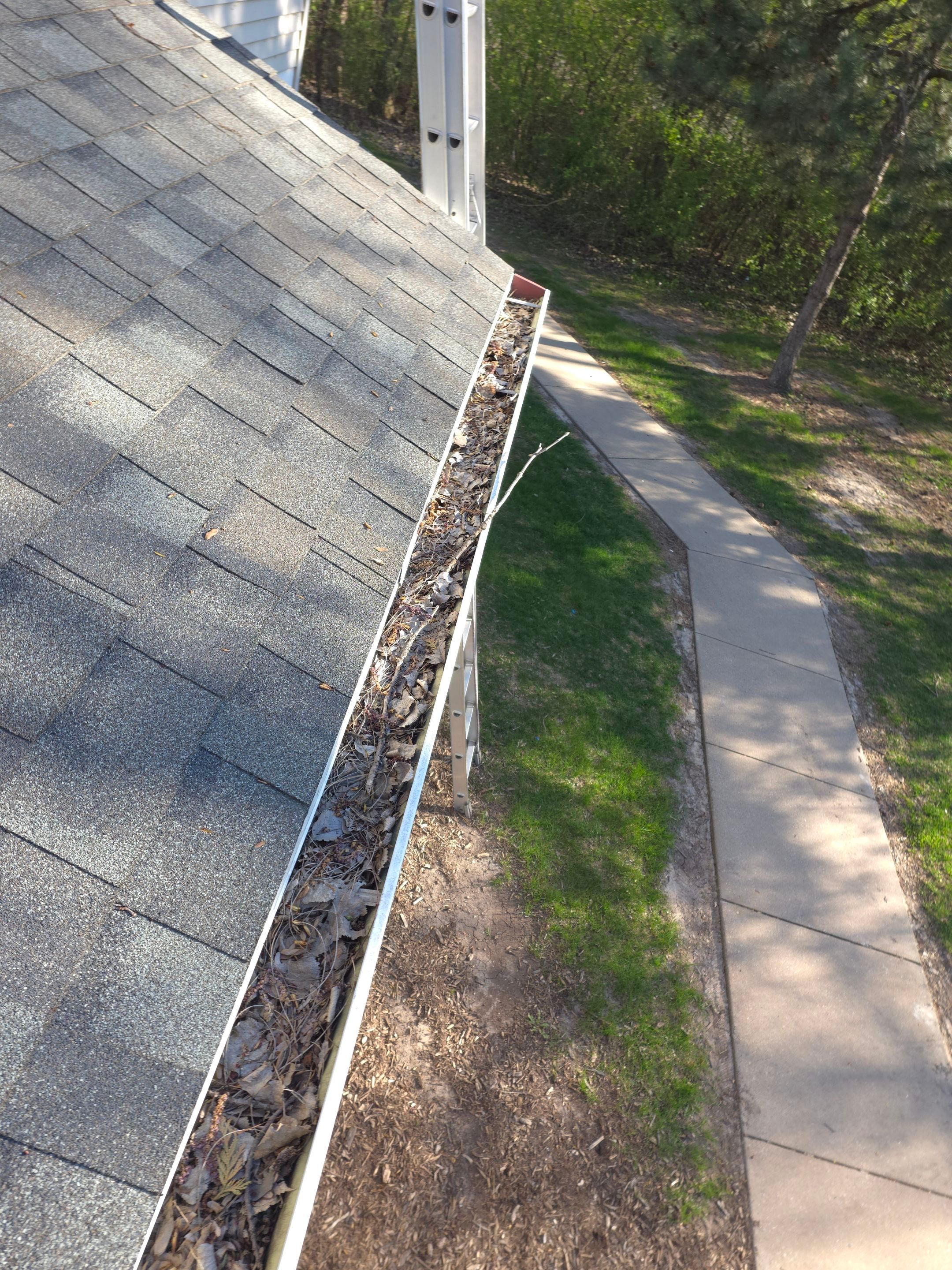 Commercial gutter cleaning Green Bay, WI before photo with filled gutters