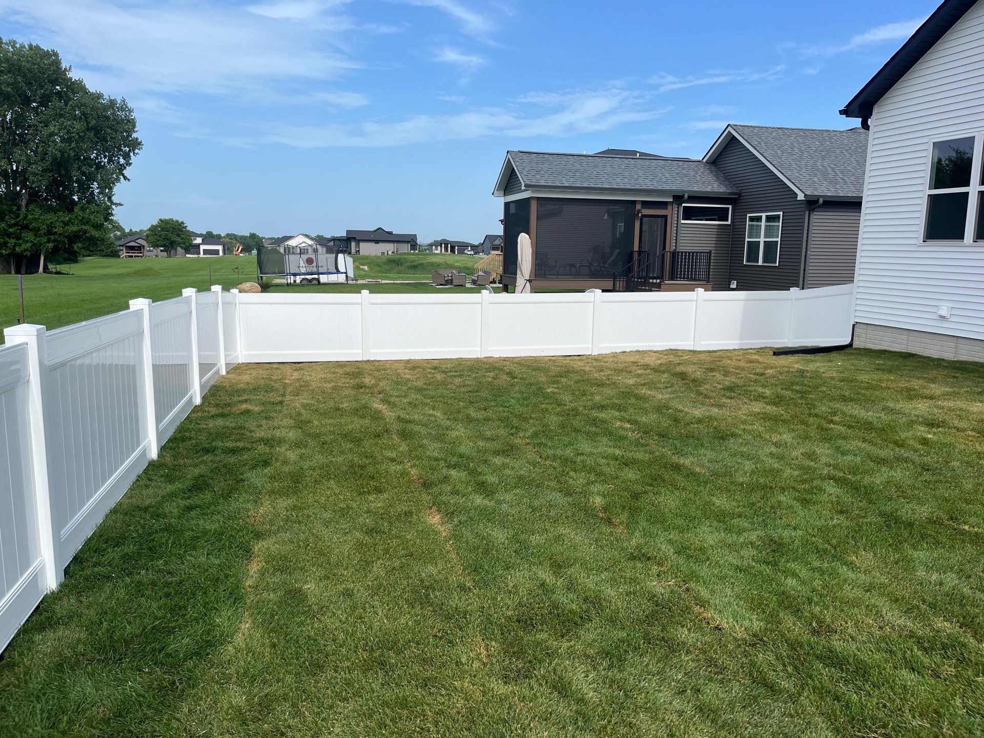 White Vinyl Privacy Fence With Pet Window in Cedar Falls by Perfect Picket Fence and Stain