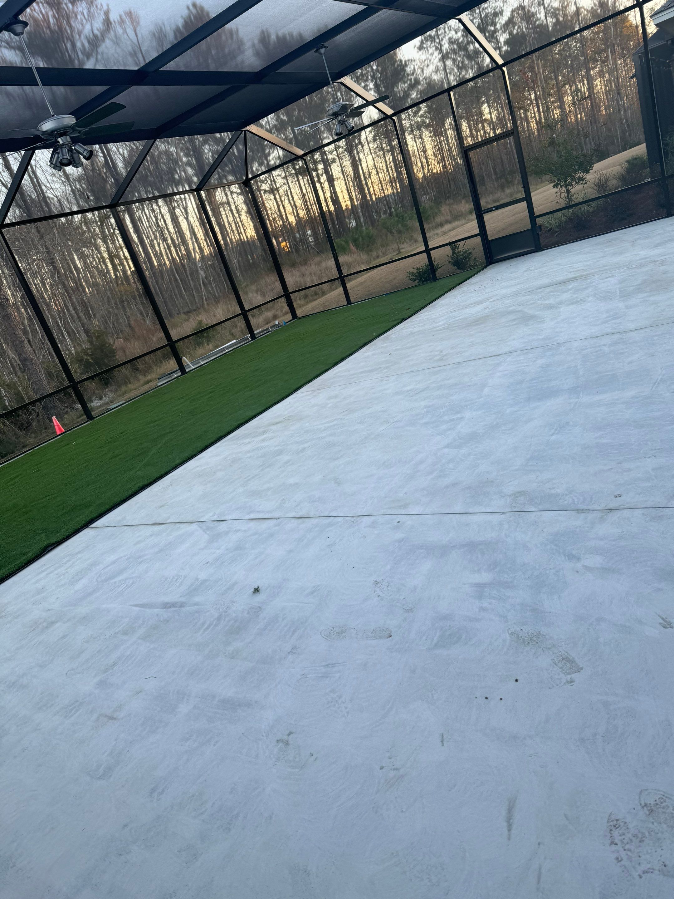 Hardeeville Screened-In Concrete Patio and Integrated Artificial Turf by Lowcountry Scapes, LLC