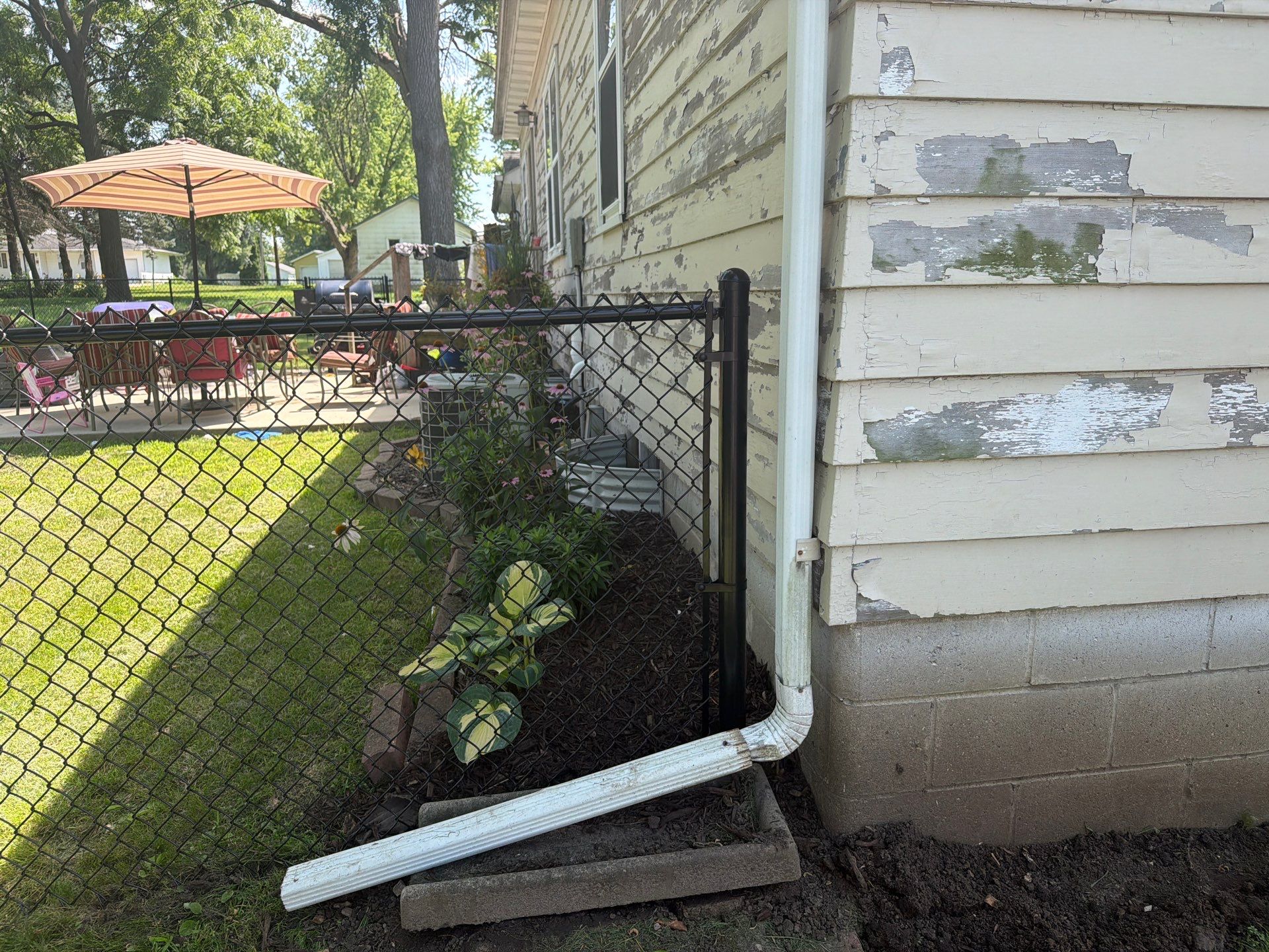 Black Chain Link Backyard Fence Installation in Tripoli, IA by Perfect Picket Fence and Stain