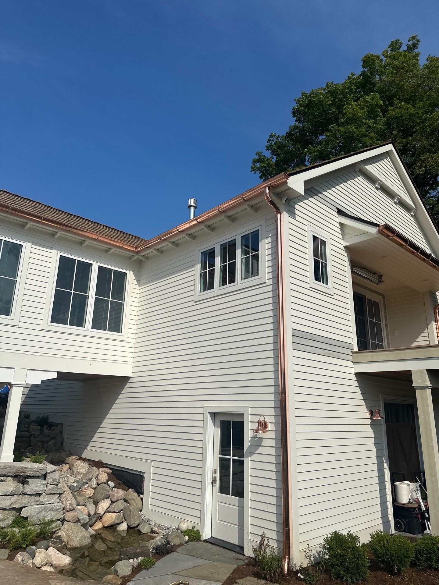 Custom Copper Gutter System and Accent Roofing in East Jordan by Rainbow Seamless Systems