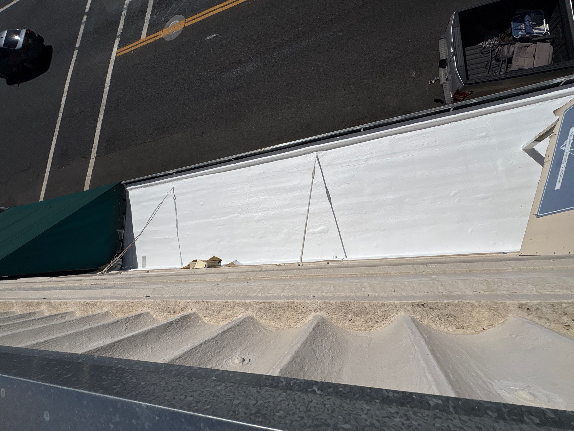 Foam and coatings on commercial roof by Straight Edge Roofing Inc