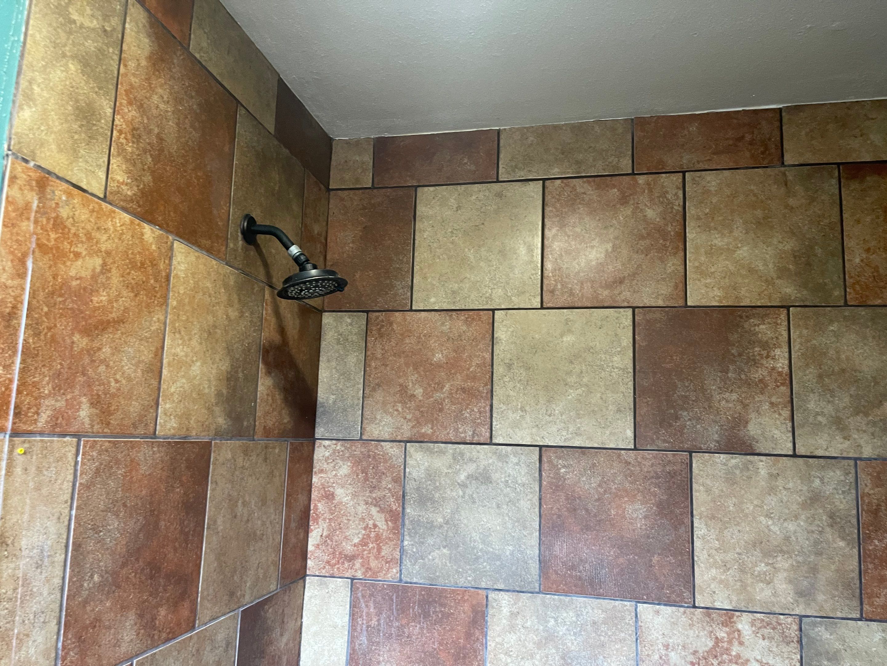 Complete Bathroom Remodel Featuring Marble Tile and Teal Herringbone Niche by Mena stone surfaces