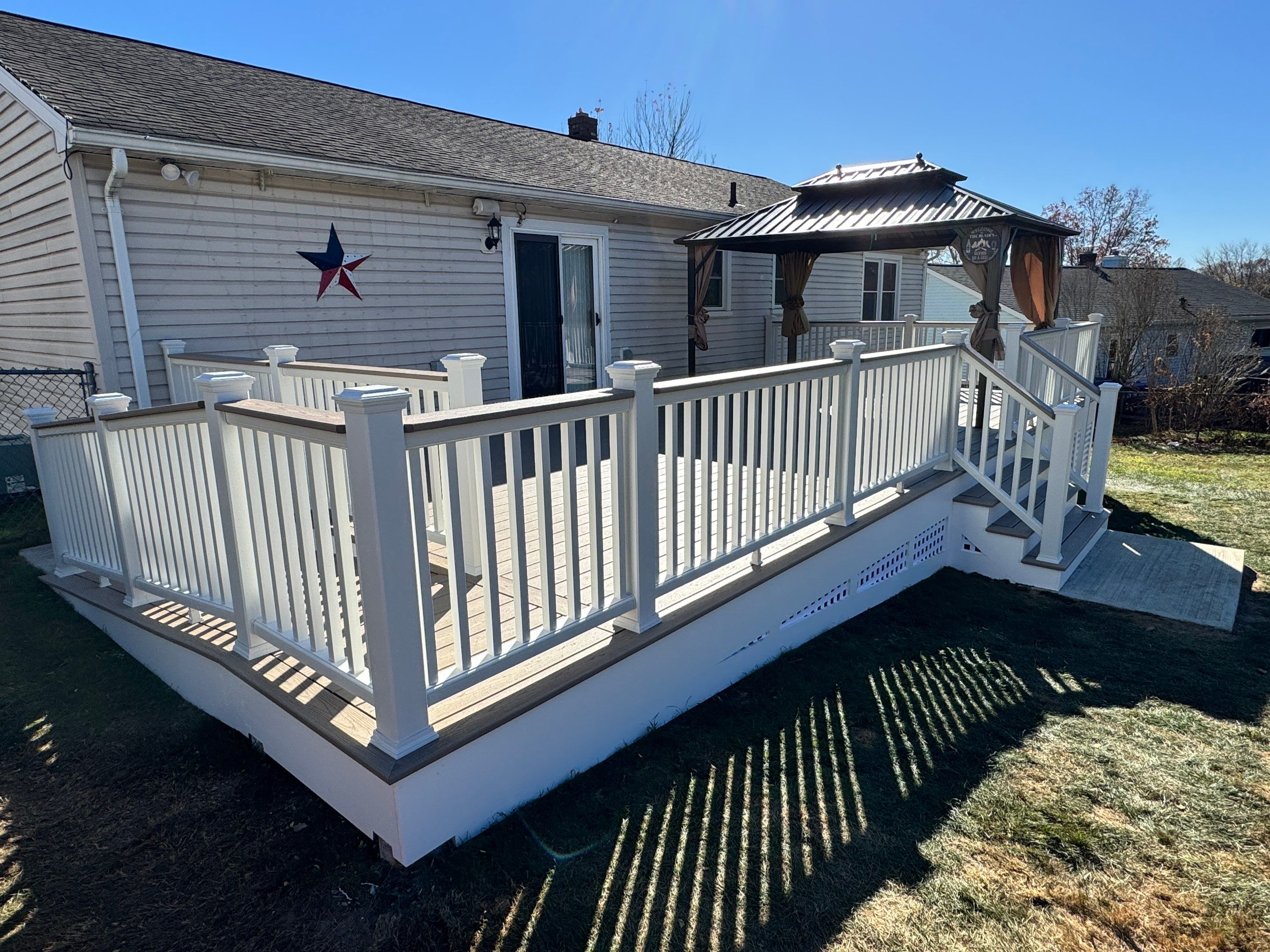 New pool deck and main deck resurface using Trex Transcend Rope Swing boards, White railing and Lattice by DiGiorgi Roofing and Siding Inc