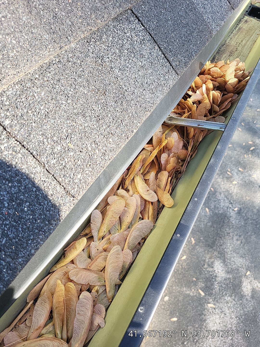 Commercial gutter cleaning Iowa before photo with filled gutters