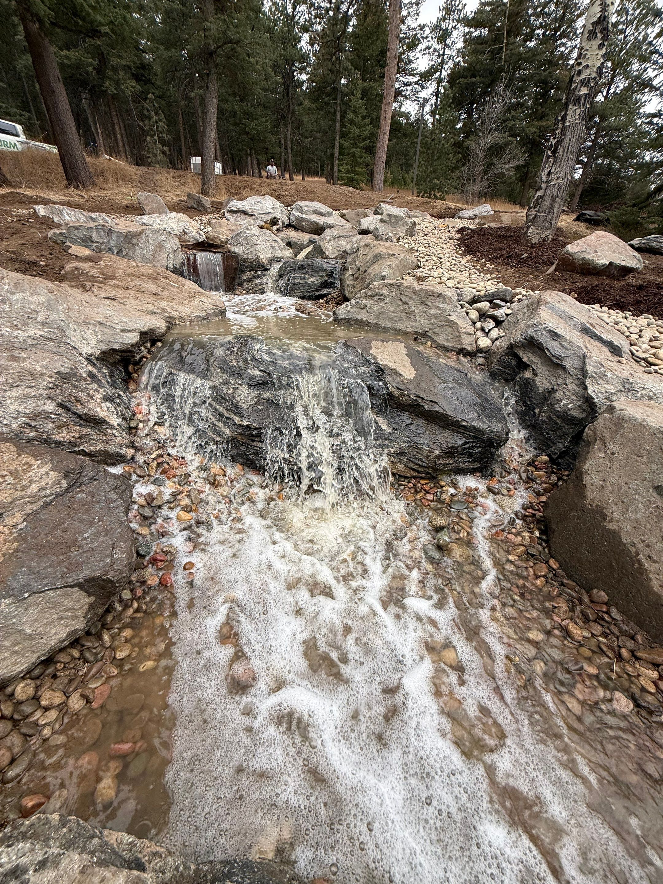 large waterfall and deck by JRM landscape & design