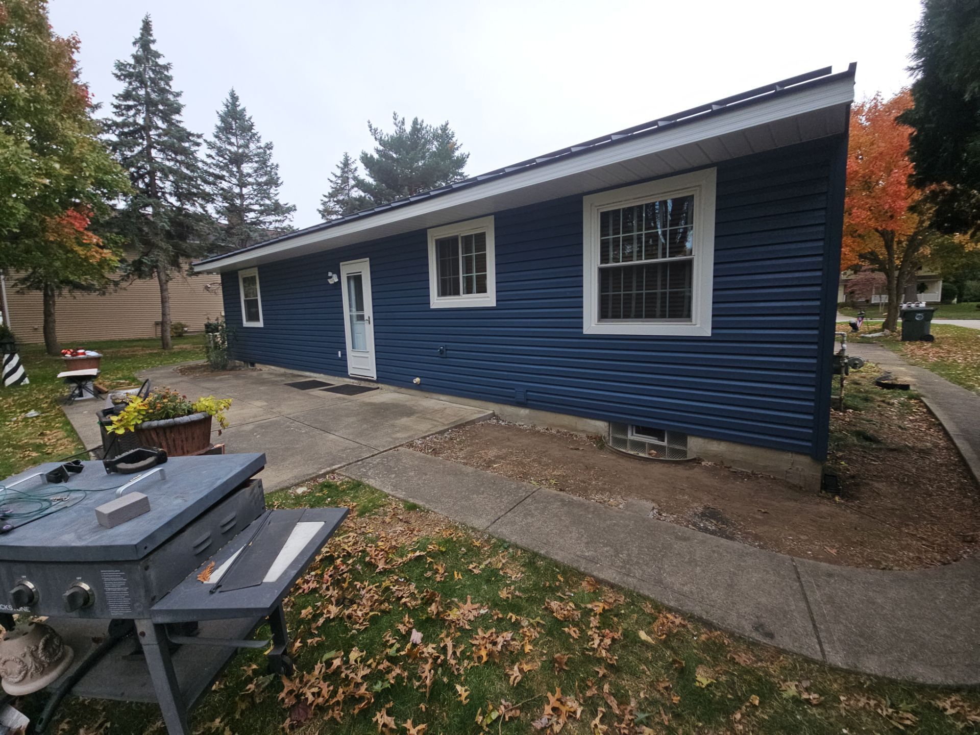 Wadsworth Exterior Transformation Featuring Blue Vertical Siding and Metal Roofing by Cornerstone Roofing And Siding