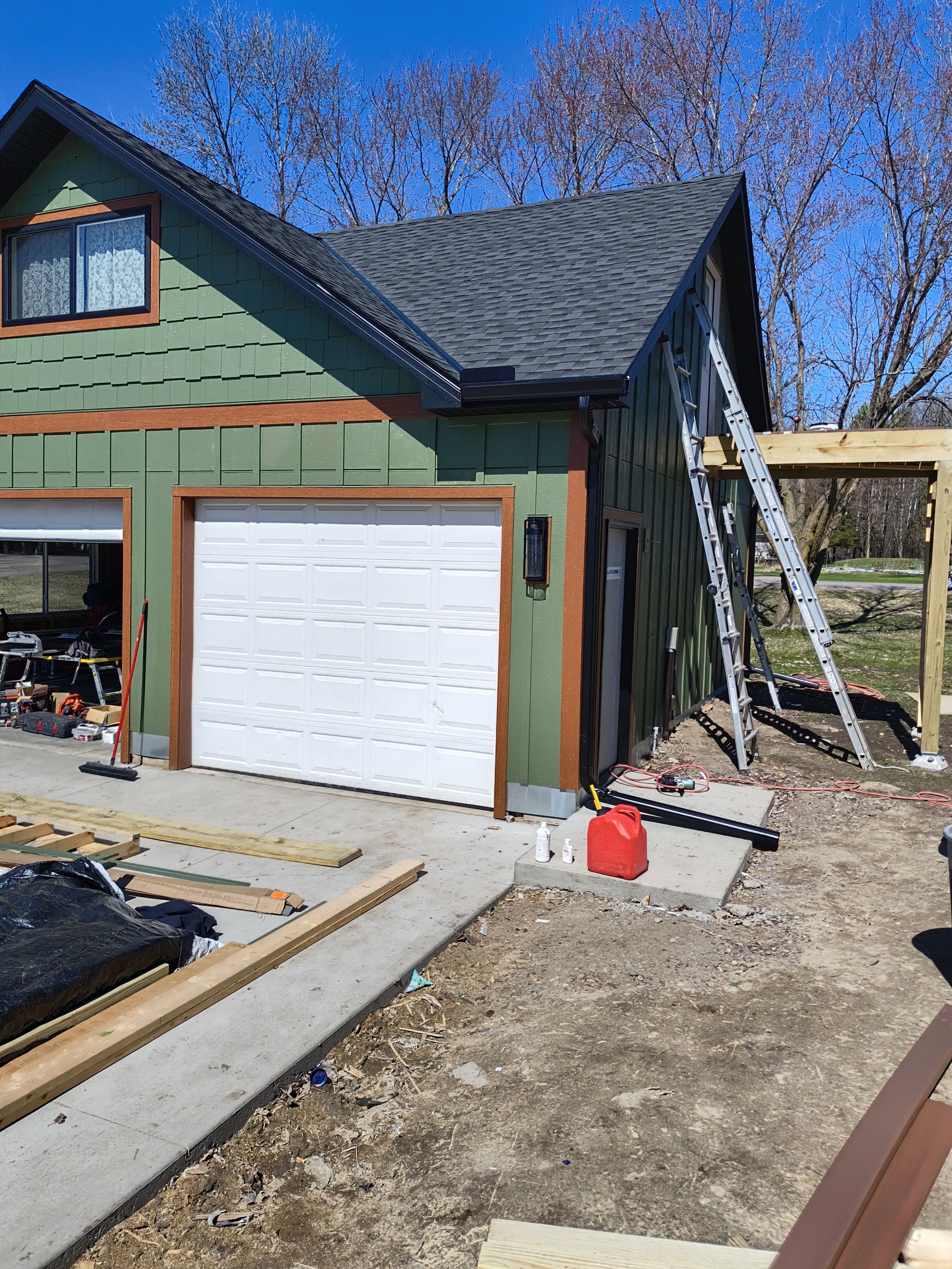 Seamless Gutter Installation in Annandale MN | 6” Black Gutters on Green Home by Next Level Seamless Gutters / Exteriors Inc.