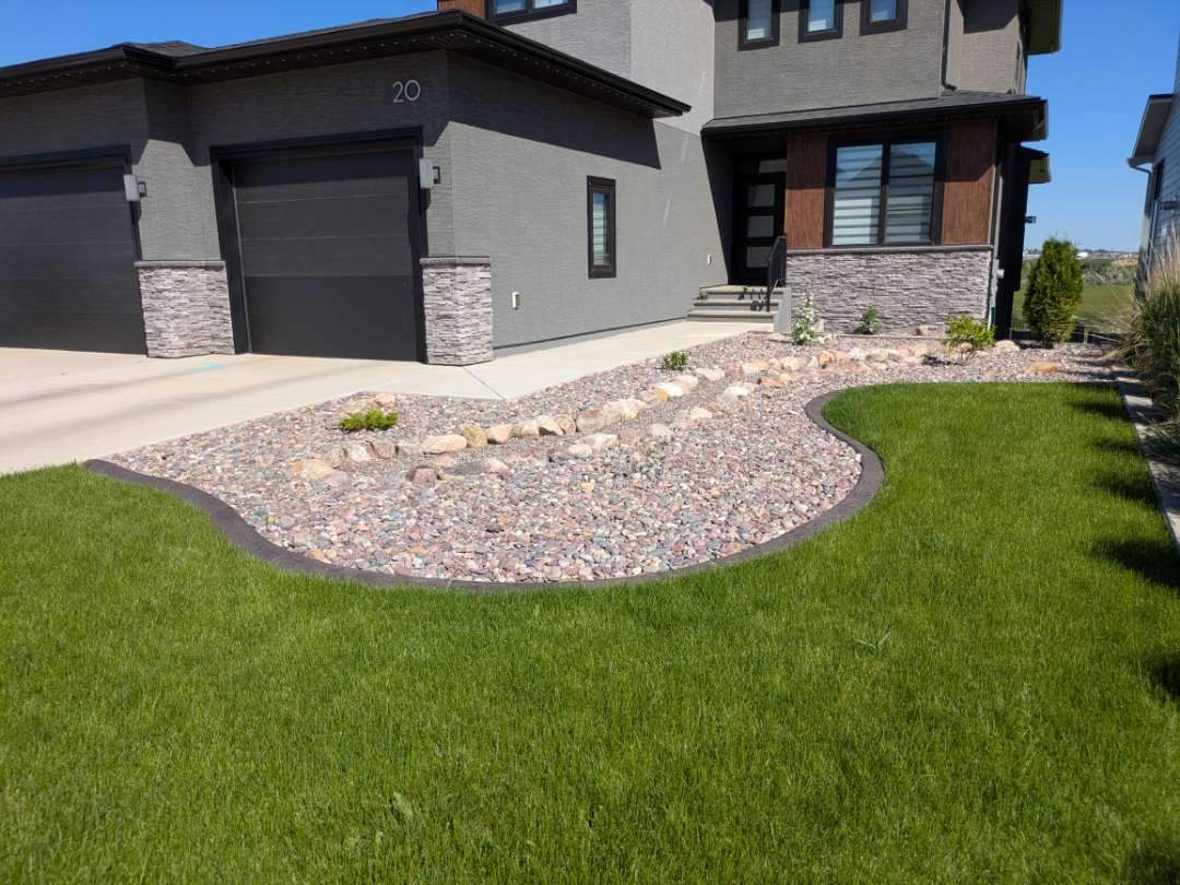 Decorative Concrete Curbing and River Rock Landscape Installation by Pump it Up Concrete Jacking