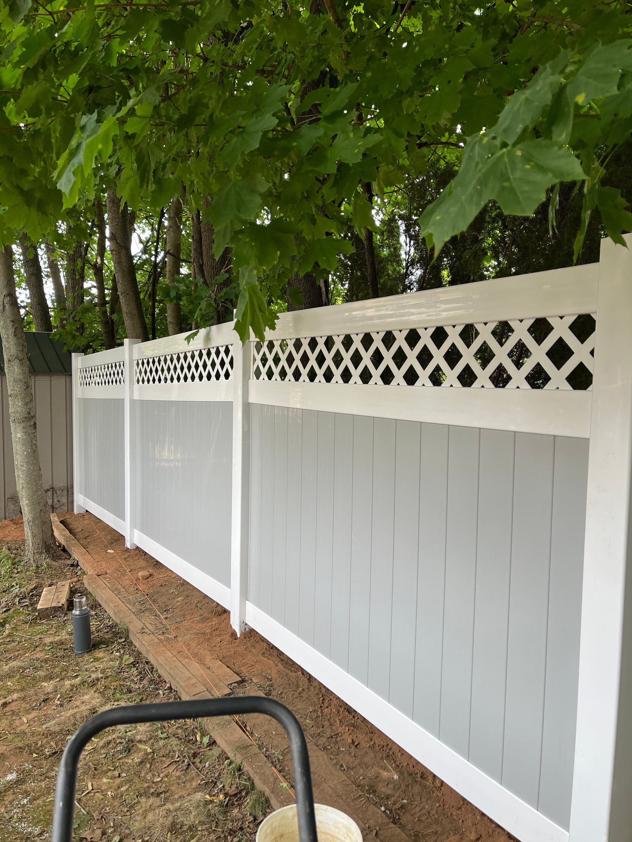 Vinyl privacy fence, Decorative lattice top. Two toned coloring White and Gray by DiGiorgi Roofing and Siding Inc