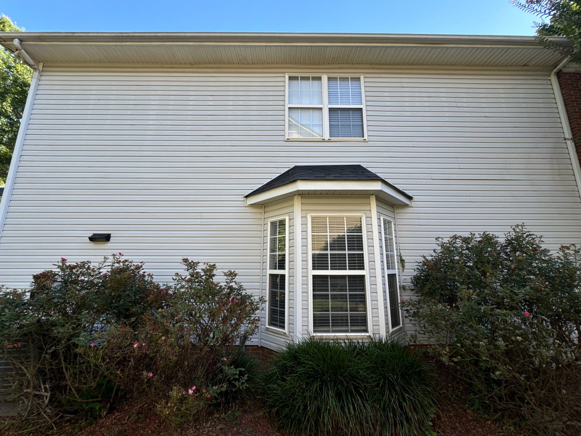 pressure washing company cleaning the exterior siding of a house in winston salem nc