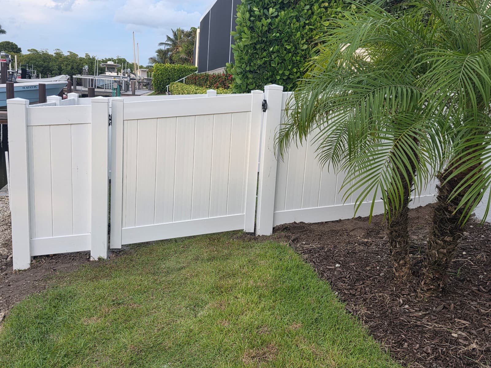 Marco Island Waterfront Vinyl Privacy Fence and Aluminum Railing by True Fence LLC