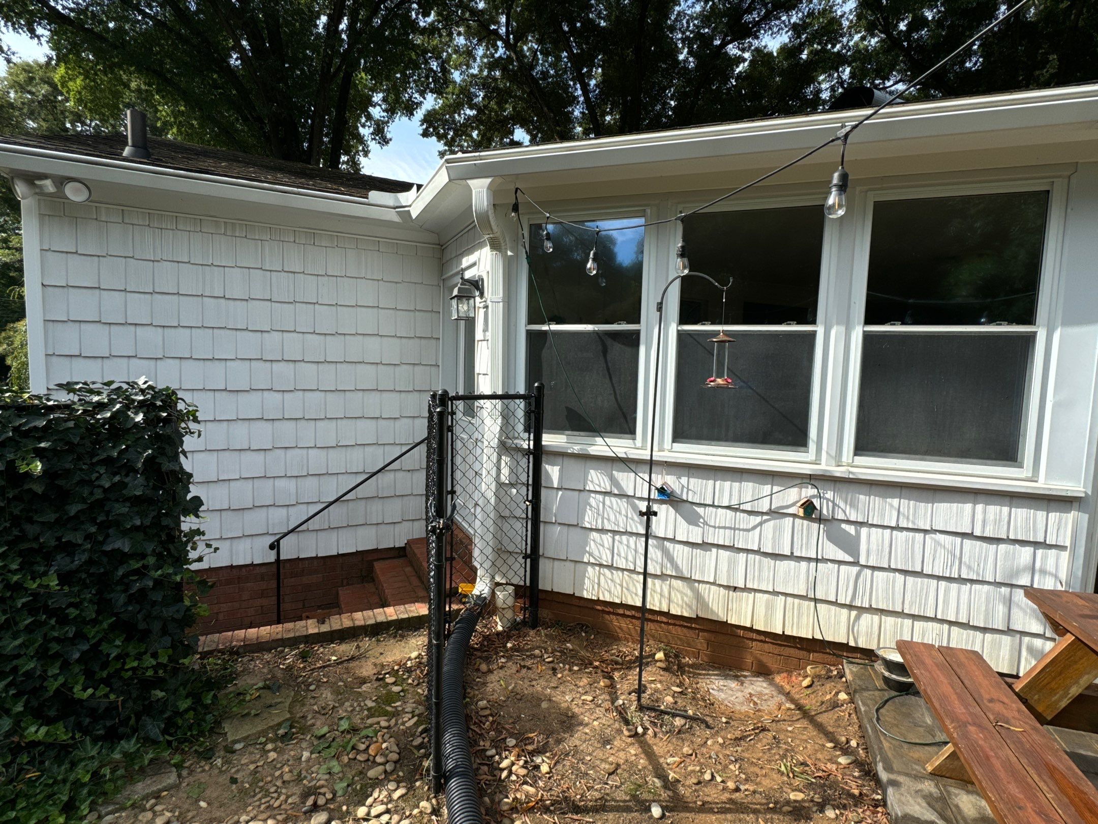 cleaning the exterior walls and windows and removing debris from the foundation and surrounding areas of the house