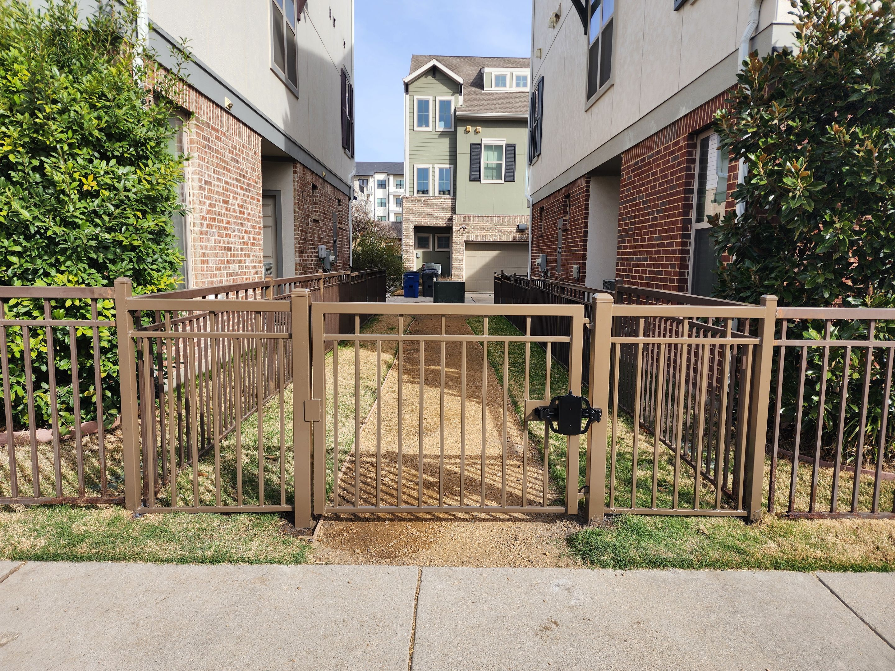 Arbor with Wrought Iron Fencing by 3:16 Roofing and Construction