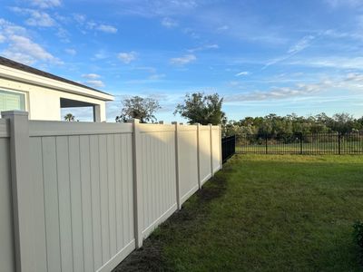 Vinyl Fence Installation using Vinyl Fence and a Black 3 Rail Aluminum Fence