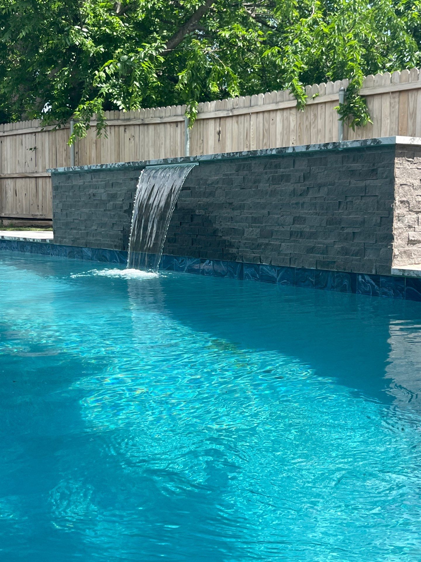 Geometric Pool with Stone Waterfall Wall by Pinnacle Pools and Spas - DFW