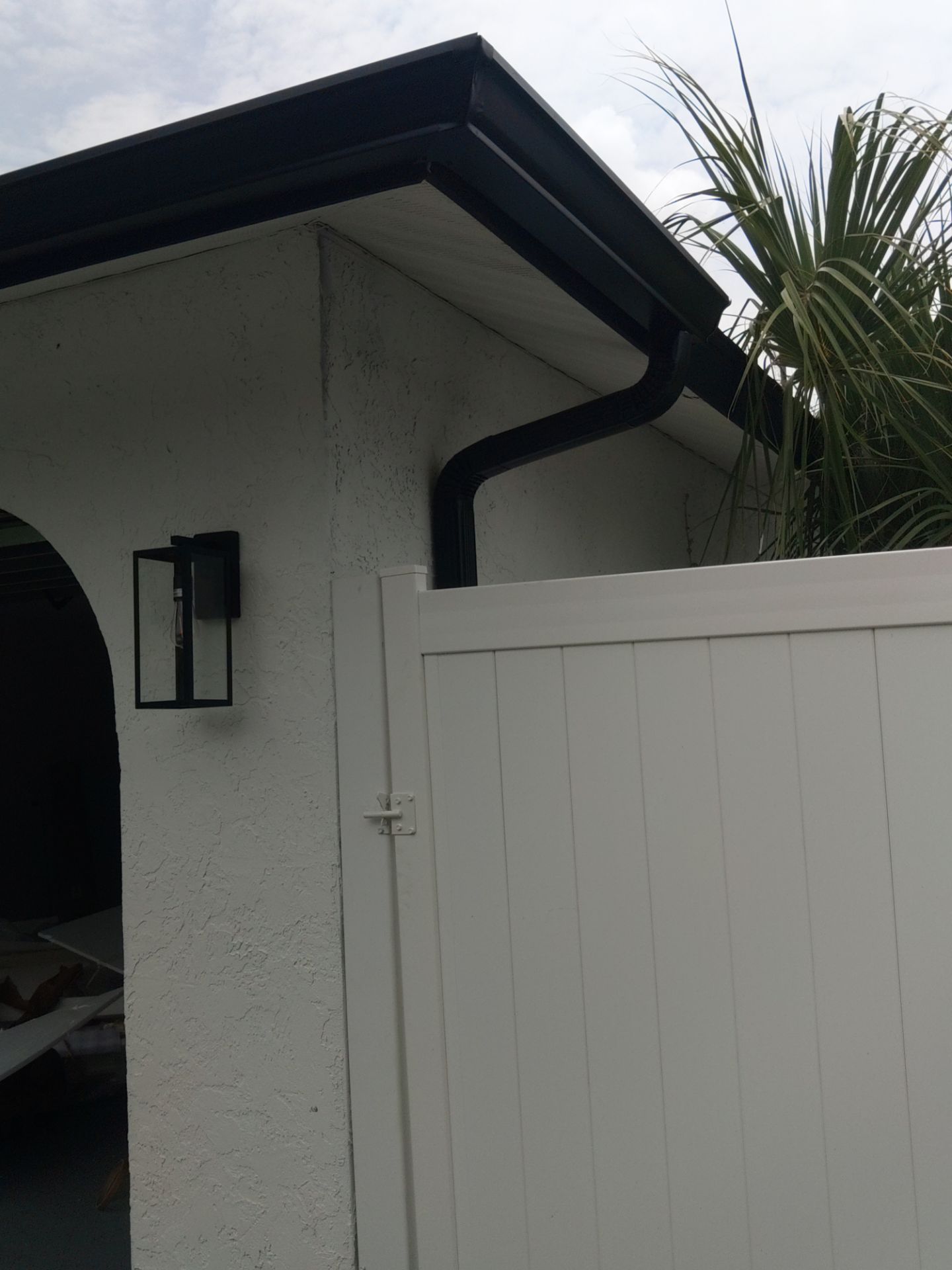 Black seamless gutters and downspouts installation in Sarasota, FL by Gutter Professors