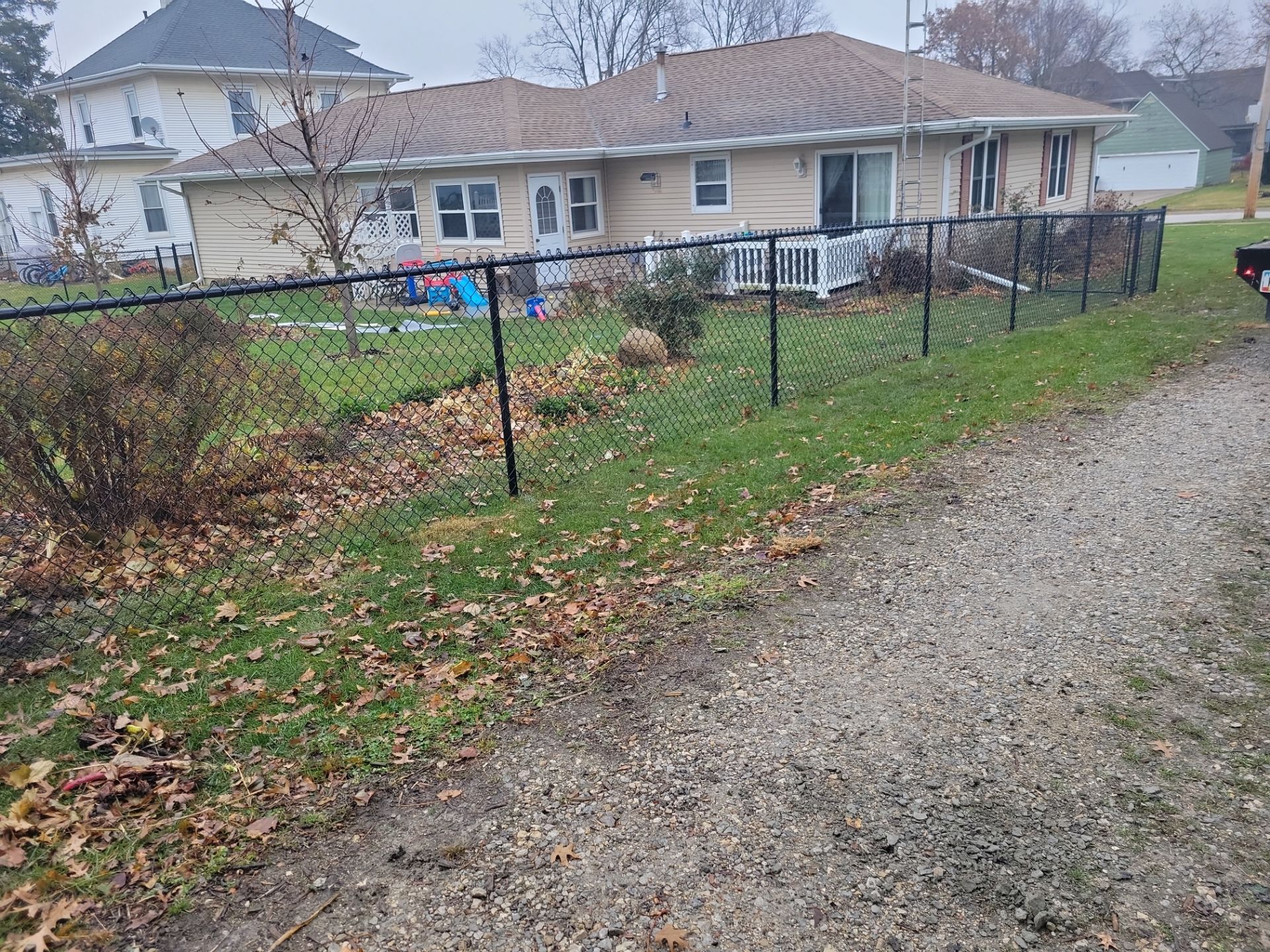 Black Vinyl-Coated Chain Link Fence Installation in Aplington by Perfect Picket Fence and Stain