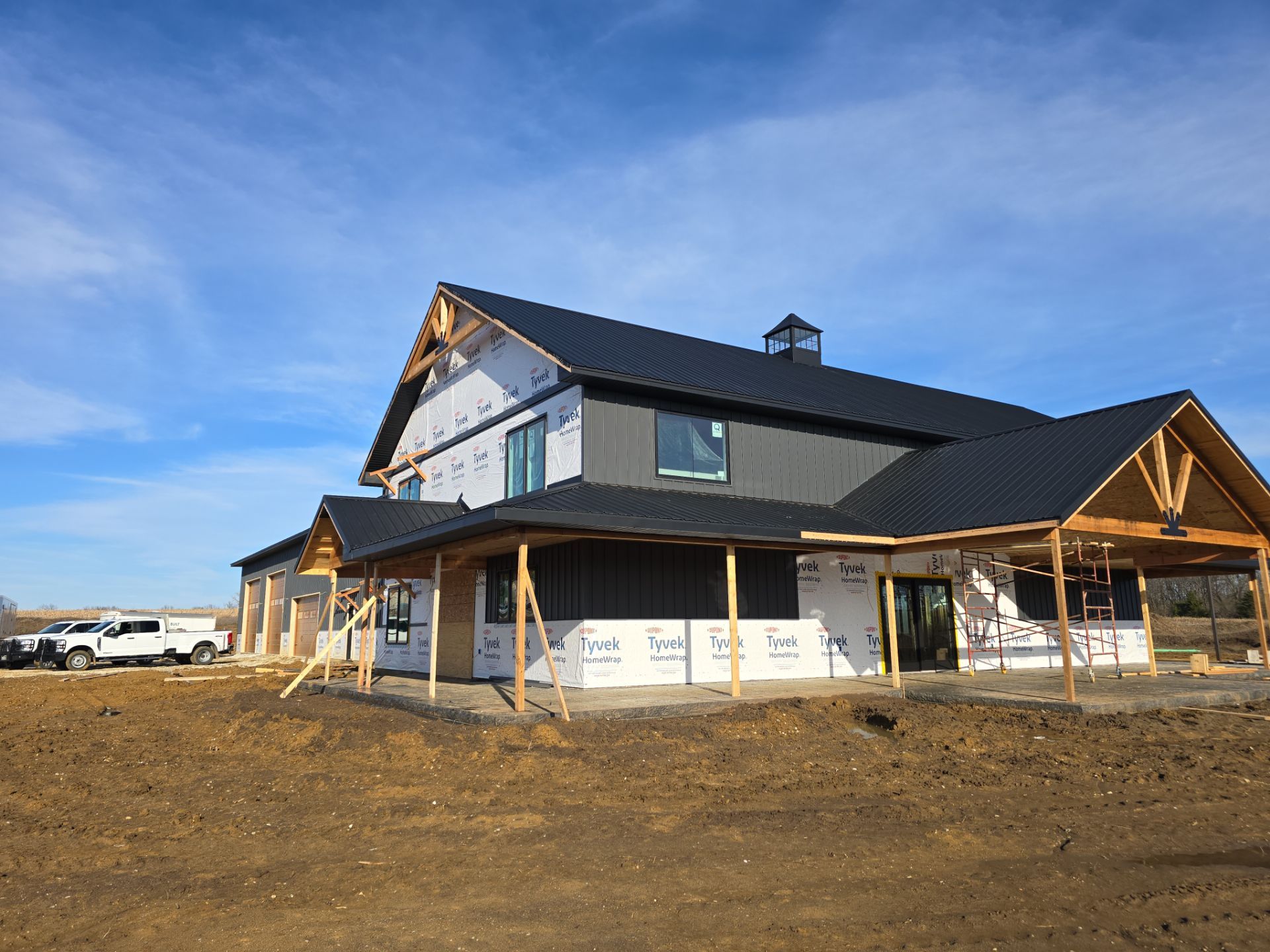 New Home construction w/ board and batten sides and metal roof  by Miles Construction 