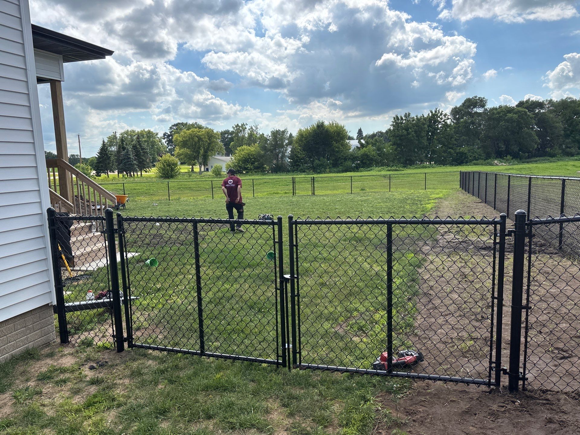 Black Vinyl-Coated Chain Link Fence and Residential Site Grading by Perfect Picket Fence and Stain
