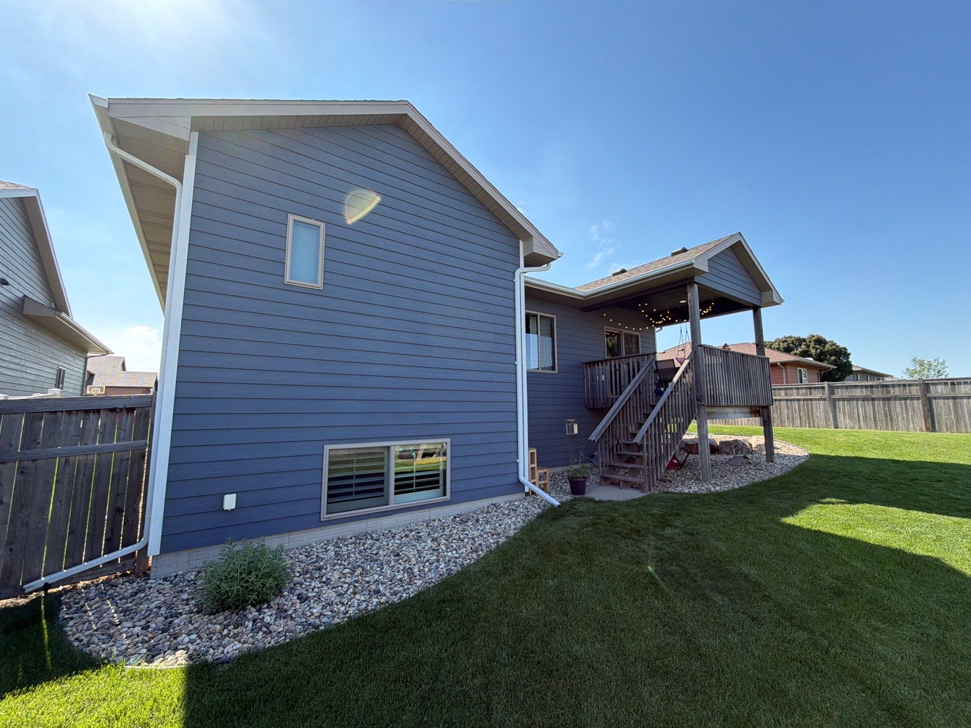 Full Exterior Home Painting on Blue Lap Siding in Sioux Falls by Select Painting, Coatings & Garage Cabinets