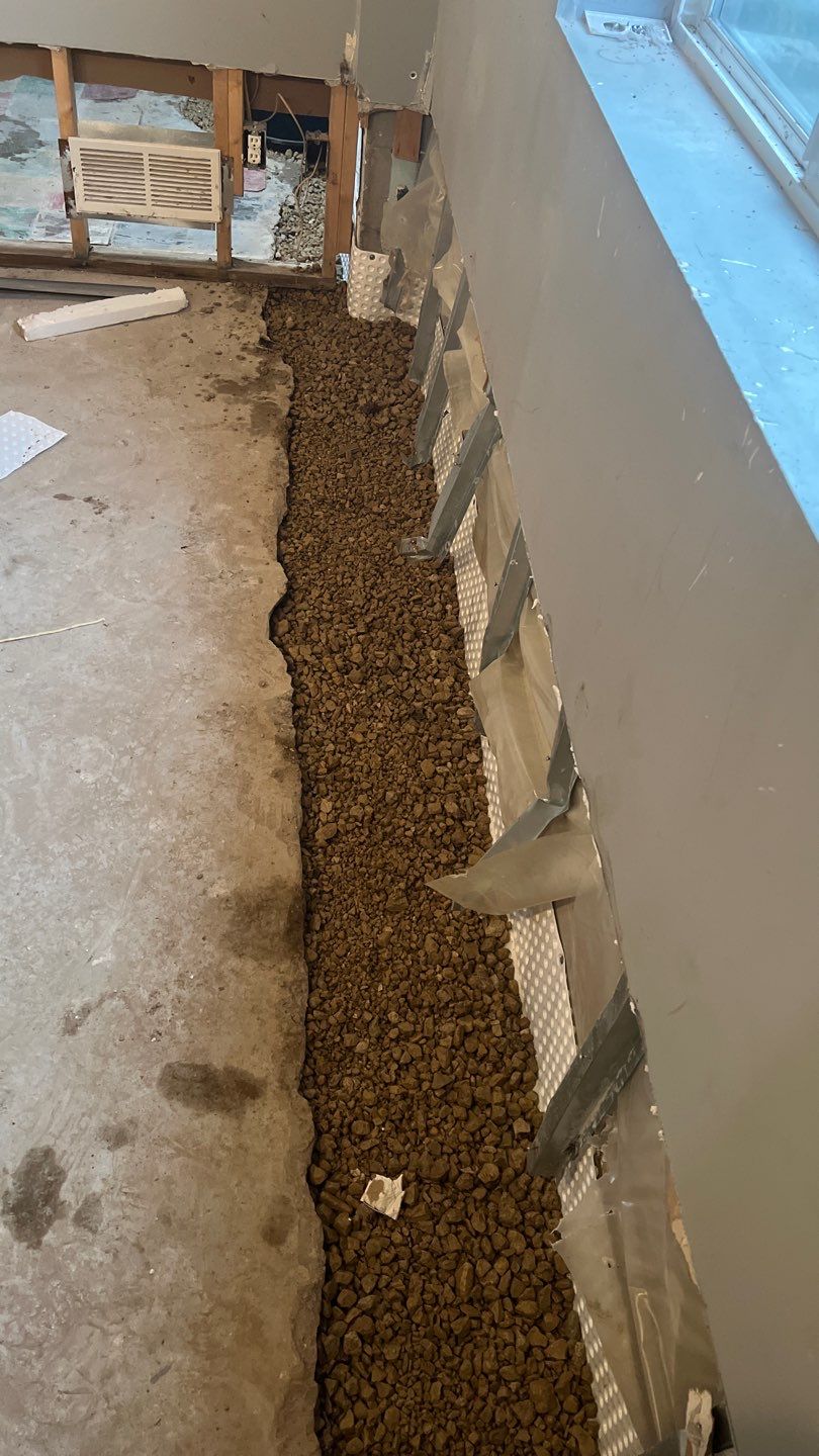 Interior drain tile system installation by ACE Waterproofing & Basement Solutions
