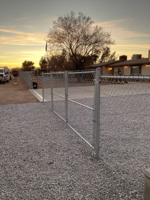 Sleek chain link fence installation with a solar motorized gate