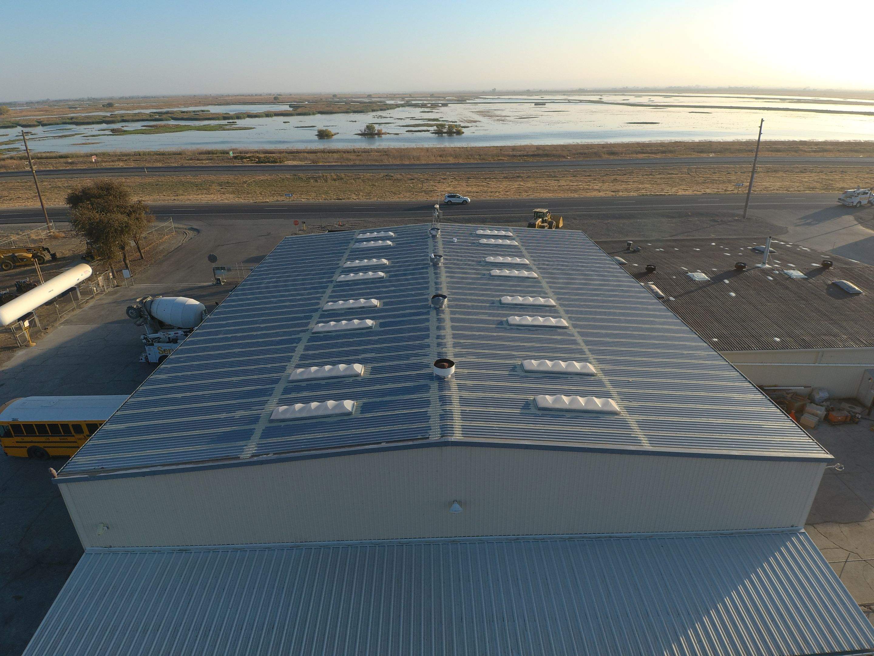 Metal roof restoration on commercial roof using Conklin Benchmark/ PUMA XL acrylic coatings over metal and foam by Straight Edge Roofing Inc